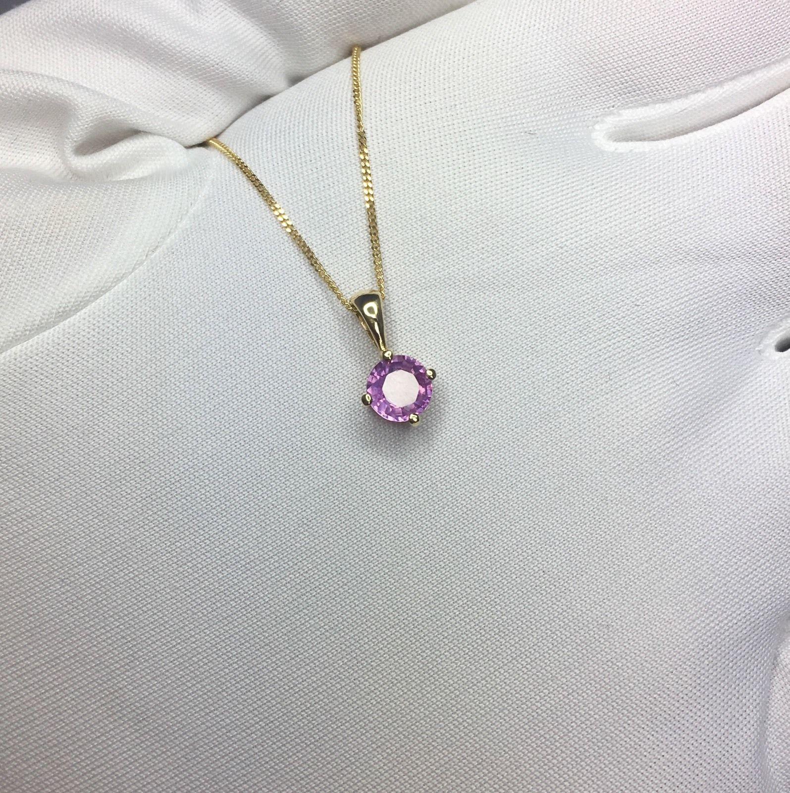 Natural vivid purple pink sapphire solitaire pendant.
Beautiful round cut Sapphire. Set in a fine 18k yellow gold pendant setting. 

Totally untreated and unheated. Very rare for Sapphires.

0.71 carat stone with a vivid purplish pink colour and