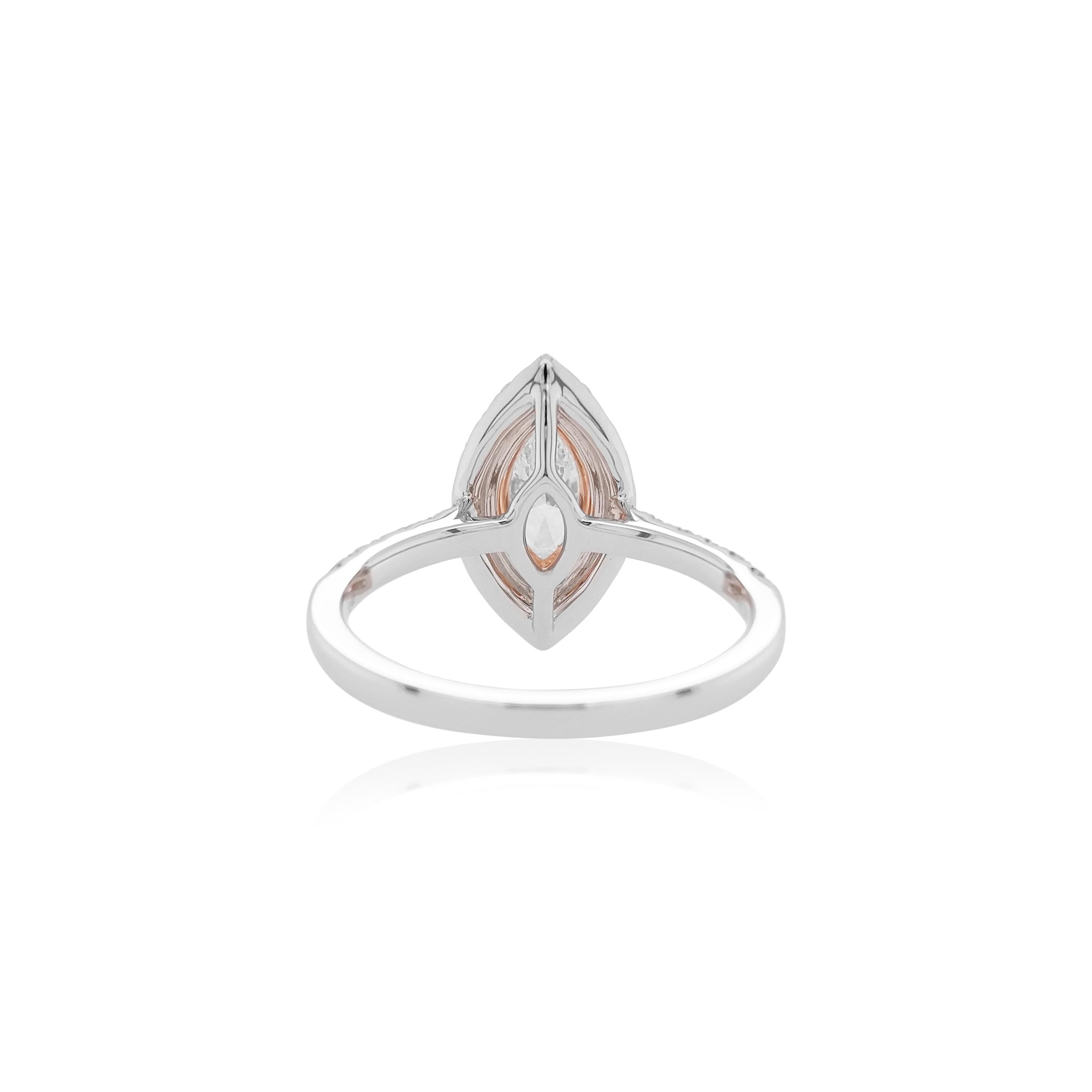 This striking 18K gold ring features an exceptional quality Marquise-shape White Diamond at its centre, surrounded by subtle halos of natural Argyle Pink Diamonds and stunning White Diamonds. Set in 18 Karat White and Pink gold to provide a unique