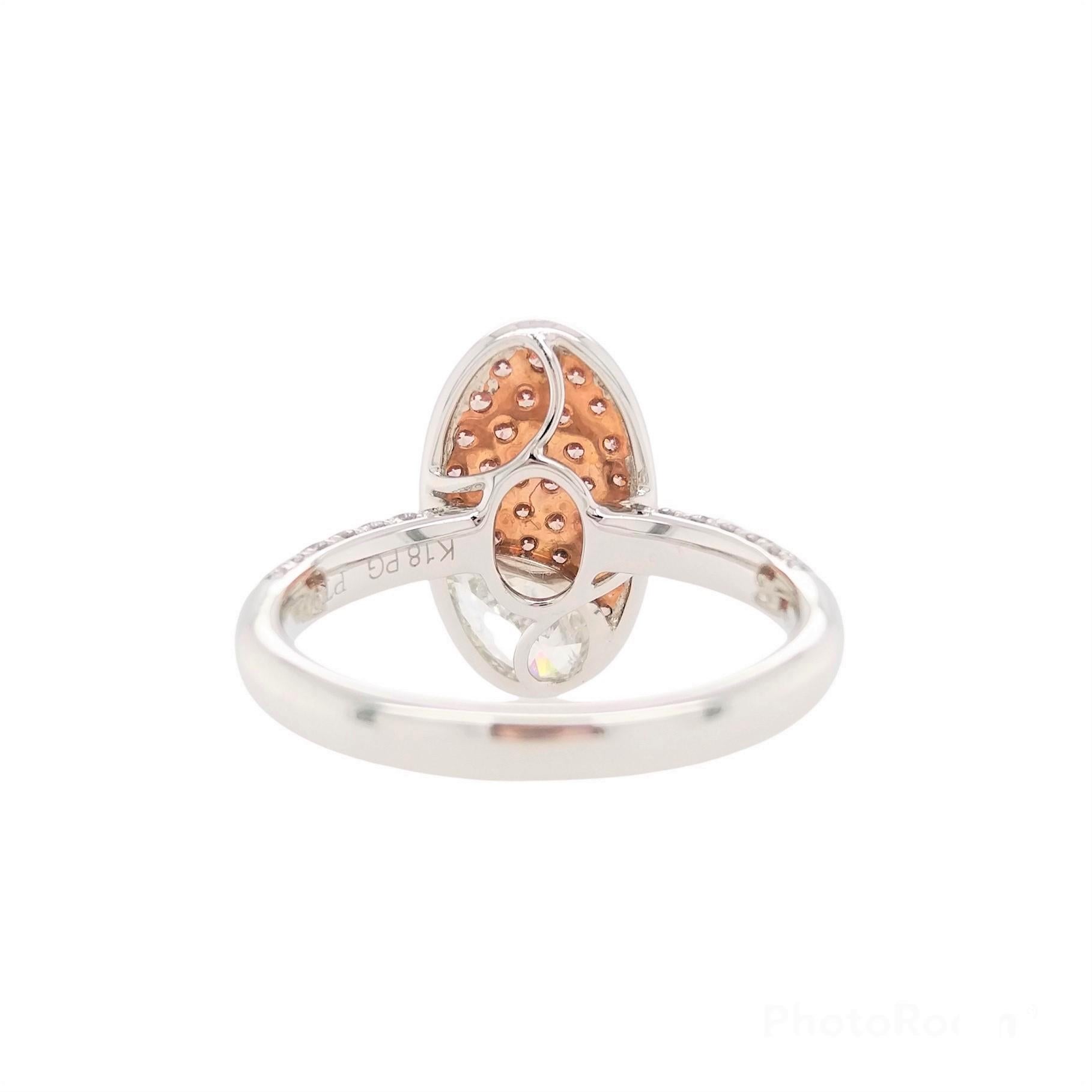 This remarkable platinum ring features an exceptional quality Pear-shape White Diamond at its forefront, accentuated by a bold pattern of natural Argyle Pink Diamonds and scintillating White diamonds. Set in platinum and 18 Karat Pink gold to