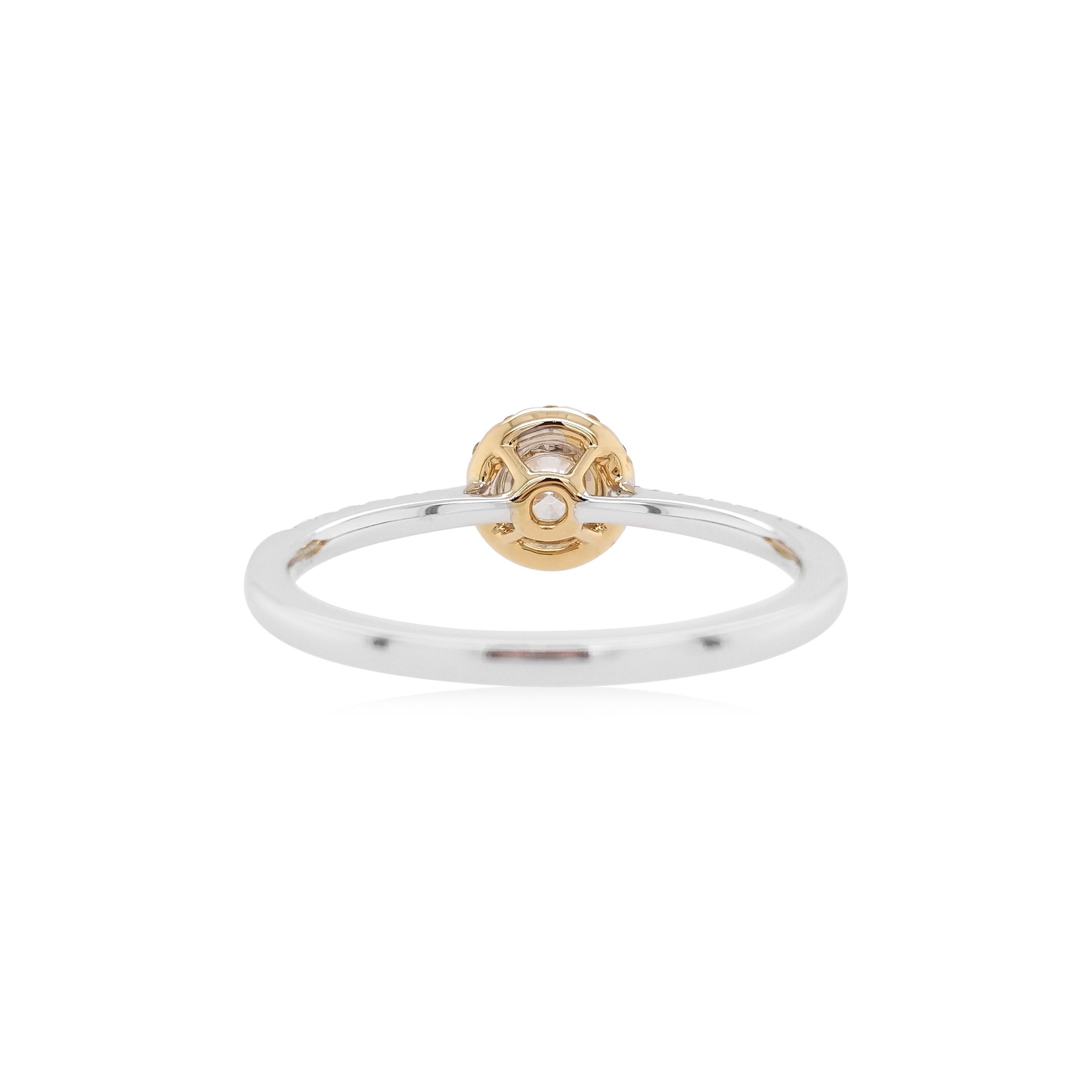 This beautiful ring features an exceptional white diamond as its focal point, which has been hand-selected by our experts. Surrounded by a halo of orange diamonds and encased in a bold 18 Karat white and yellow gold setting, the ring has been