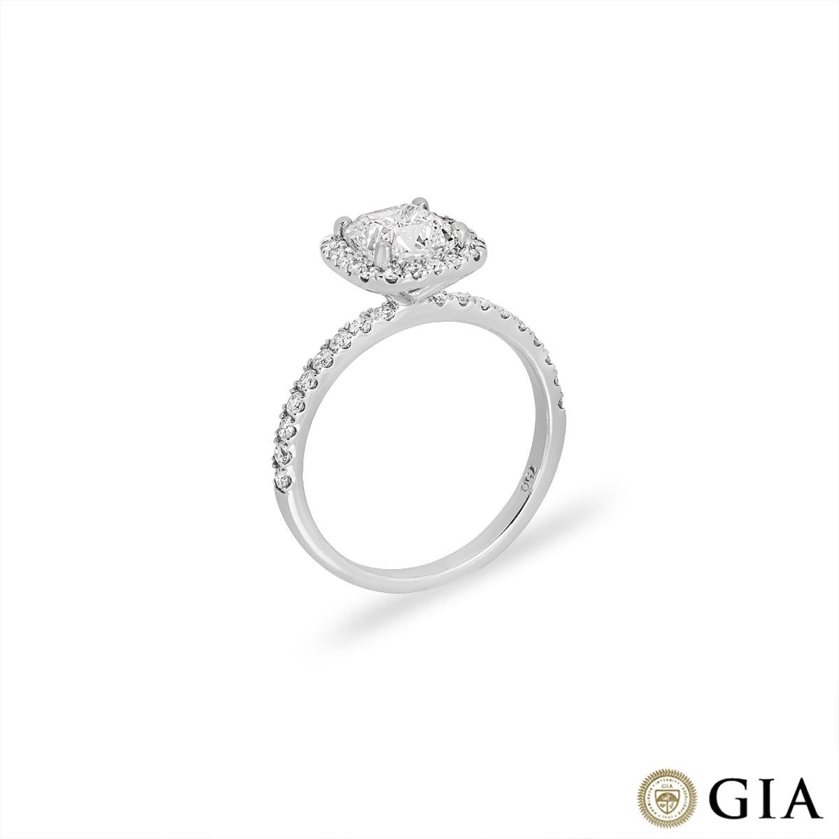 An enchanting 18k white gold diamond engagement ring. The ring features a cushion cut diamond set to the centre of a halo weighing 1.51ct, F colour and VS2 clarity. Accentuating the centre stone are 38 round brilliant cut diamonds pave set to the