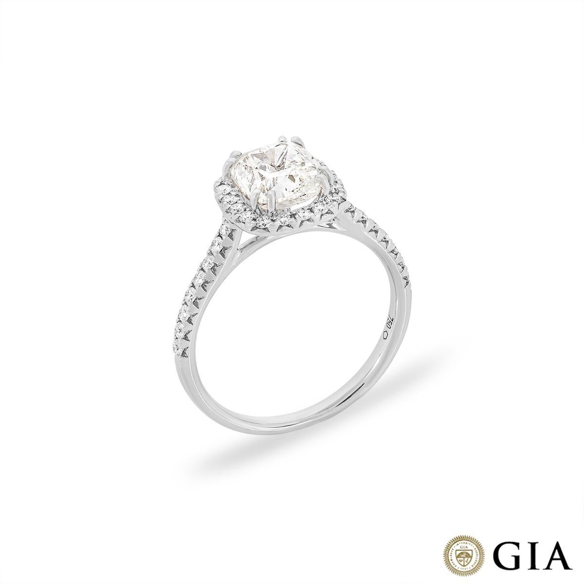 An elegant 18k white gold diamond engagement ring. The ring features a cushion cut diamond set to the centre of a halo weighing 1.81ct, J colour and SI2 clarity. Accentuating the centre stone are 34 round brilliant cut diamonds pave set to the
