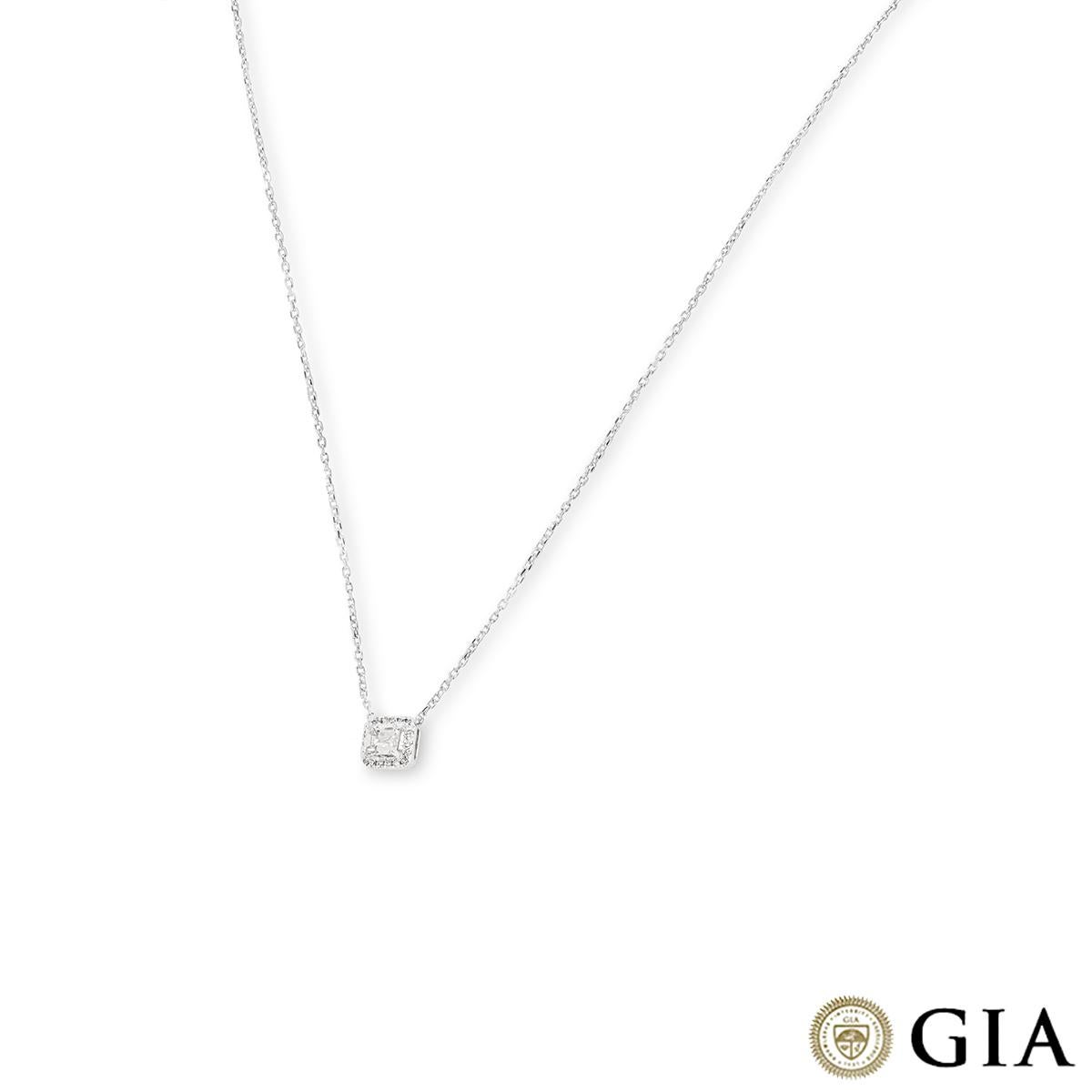A chic 18k white gold diamond pendant. The pendant features an emerald cut diamond set to the centre weighing 0.51ct, F colour and VS1 clarity. Further accentuating the centre diamond are 18 round brilliant cut diamonds pave set in a halo with an