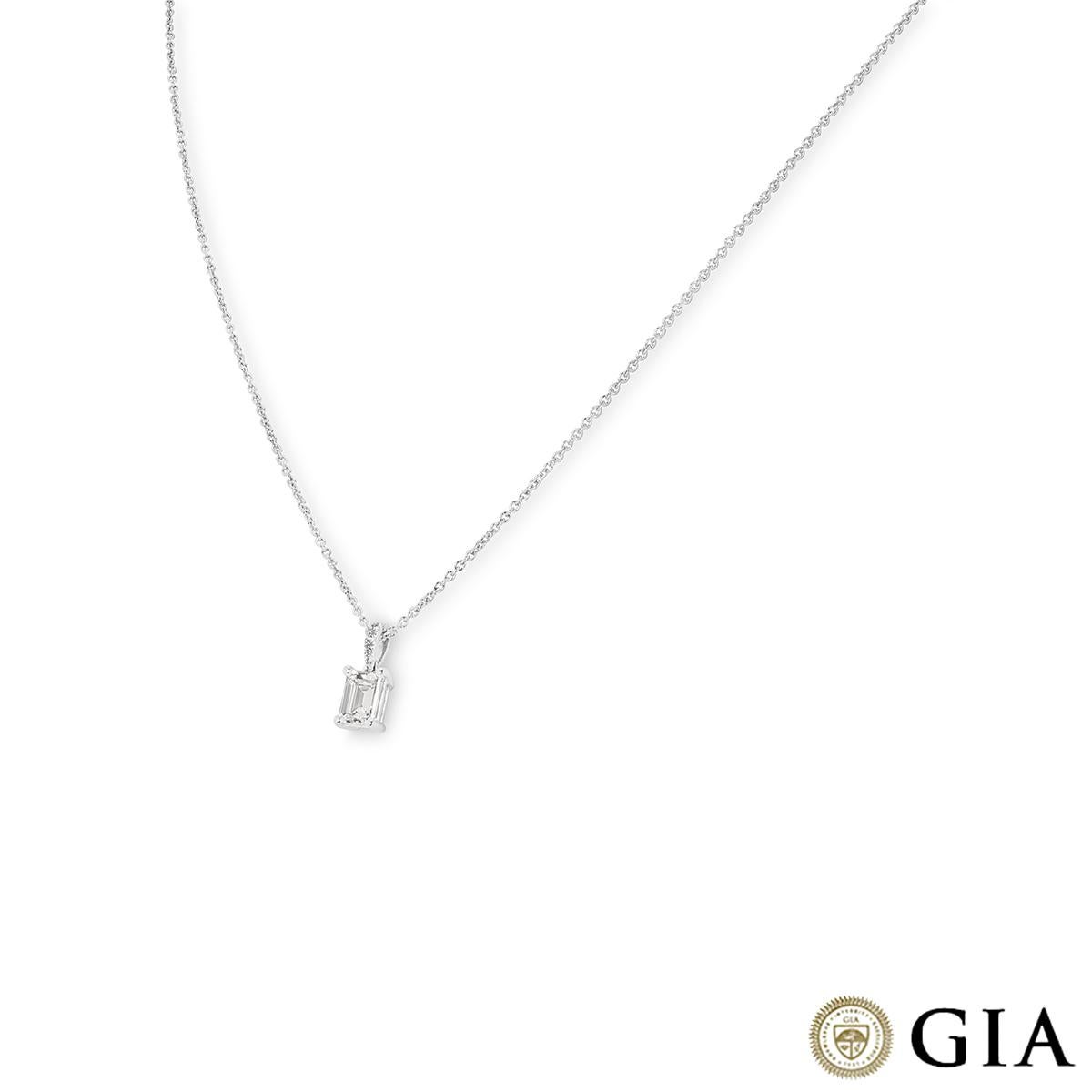 An elegant 18k white gold diamond pendant. The pendant features an emerald cut diamond weighing 0.92ct, G colour and SI1 clarity freely moving below a diamond set bail. The bail is pave set with 5 round brilliant cut diamonds with an approximate