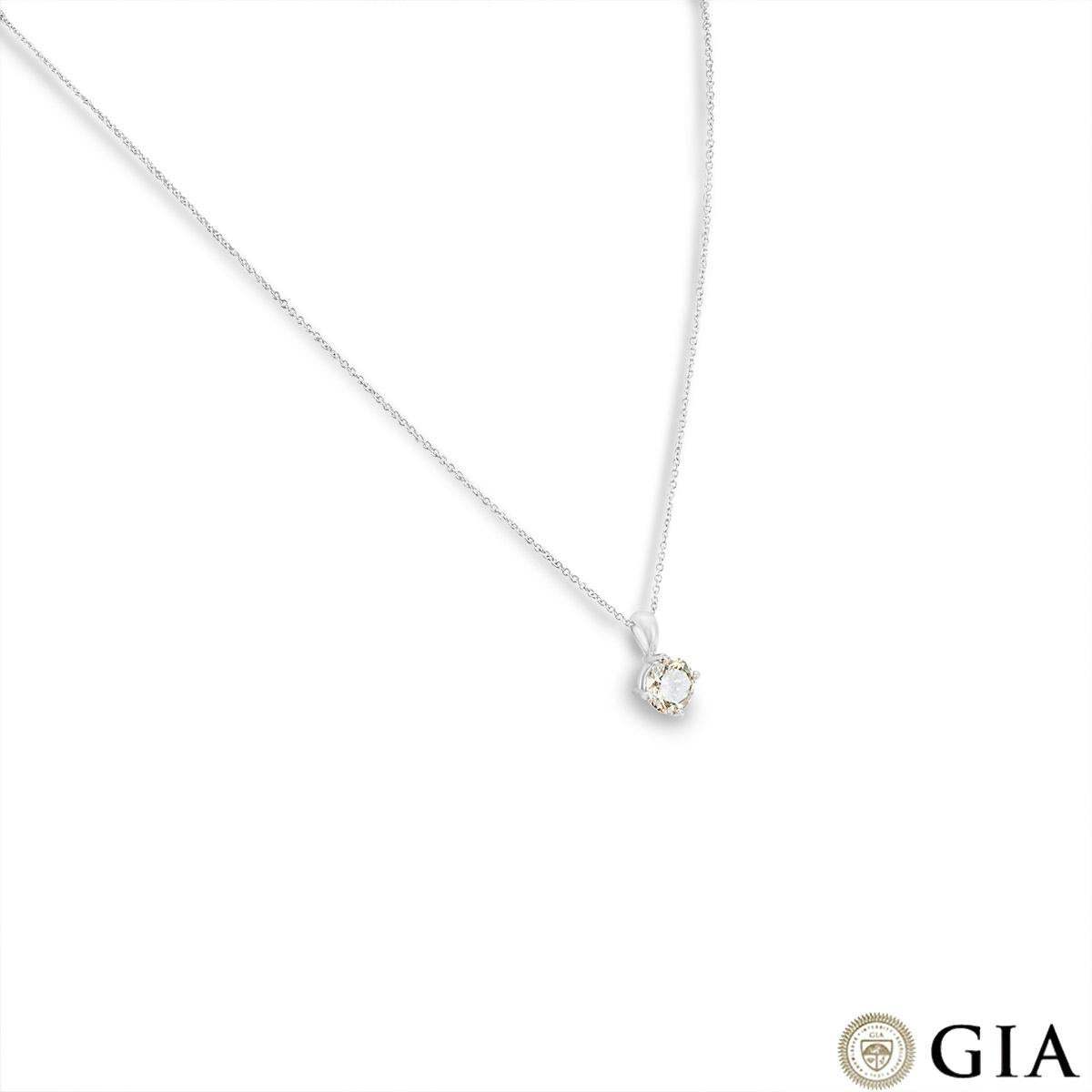 A unique 18k white gold fancy coloured diamond pendant. The four prong solitaire pendant features a round brilliant cut diamond weighing 1.50ct, fancy grayish greenish yellow colour and VS2 clarity. The pendant suspends from a 16-inch chain that
