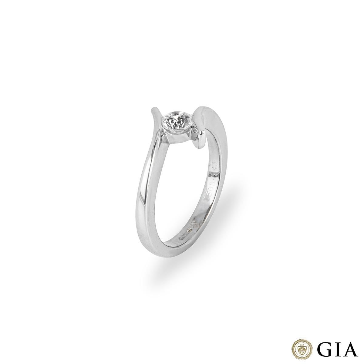An elegant 18k white gold diamond single stone ring. The ring features a modern twist design holding the diamond into place in a channel setting. The round brilliant cut diamond weighs 0.43ct, is F colour and VS1 in clarity. The ring measures
