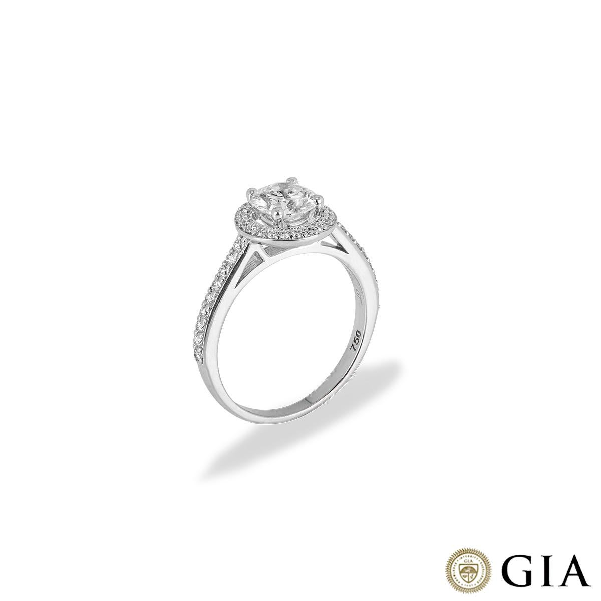 A beautiful 18k white gold diamond engagement ring. The central round brilliant cut diamond weighs 0.94ct, is F colour and VS2 in clarity with a halo of pave set round brilliant cut diamonds with a weight of 0.30ct, G-H colour and VS clarity. The