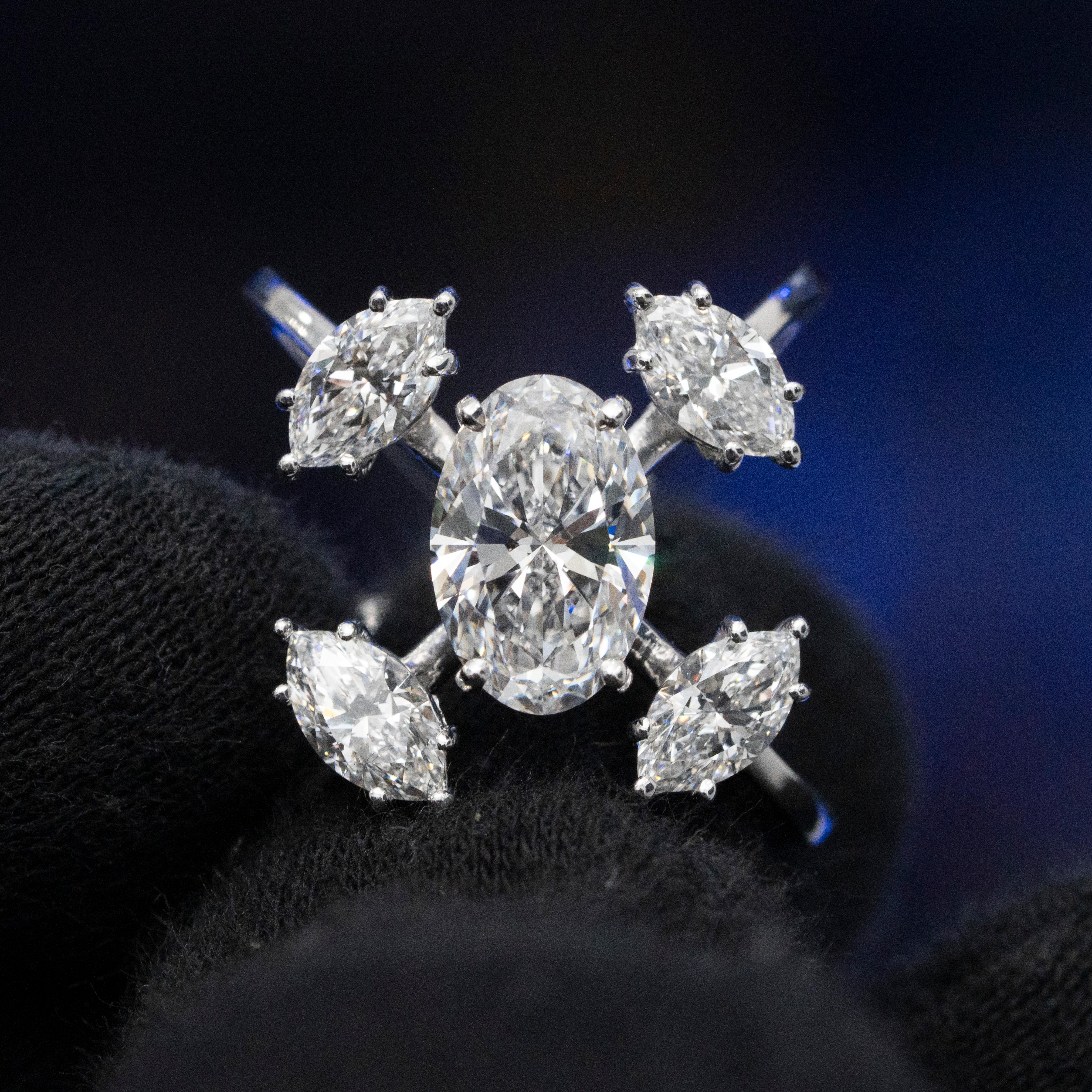 This striking ring, crafted in 18k white gold, showcases a bold and unique design with 5.03 carats of exquisite diamonds. The centerpiece features a stunning 3.01ct oval diamond with flawless D color, accompanied by 2.02ctw of brilliant marquise
