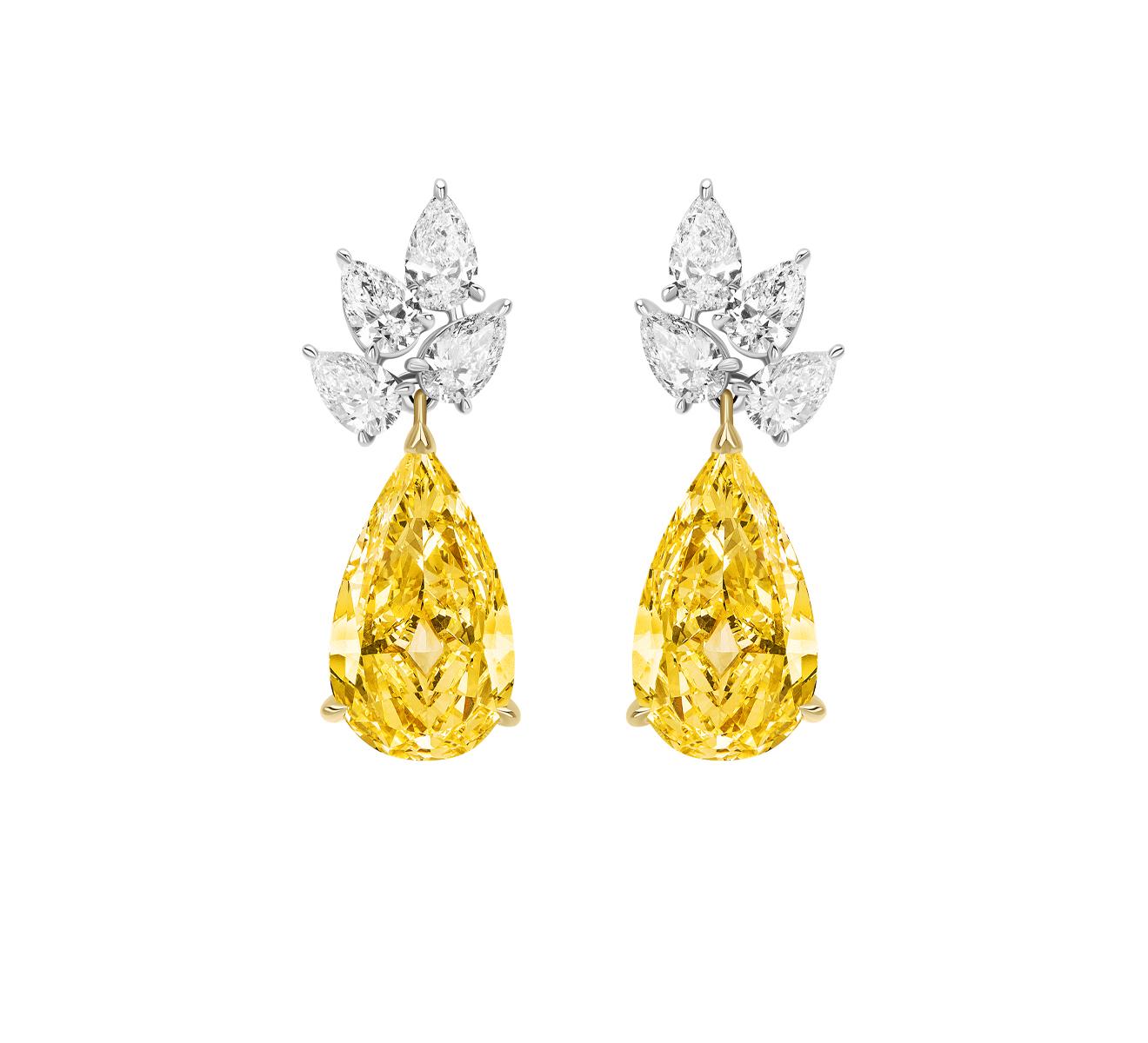 Magnificent Pear Shape Yellow Diamonds suspended from a Cluster of White Pear shape Diamonds. 

Yellow Diamonds weighing 10.01 Carats
White Diamonds weighing 4.05 Carats. 

Set in Platinum and 18 Karat Yellow Gold