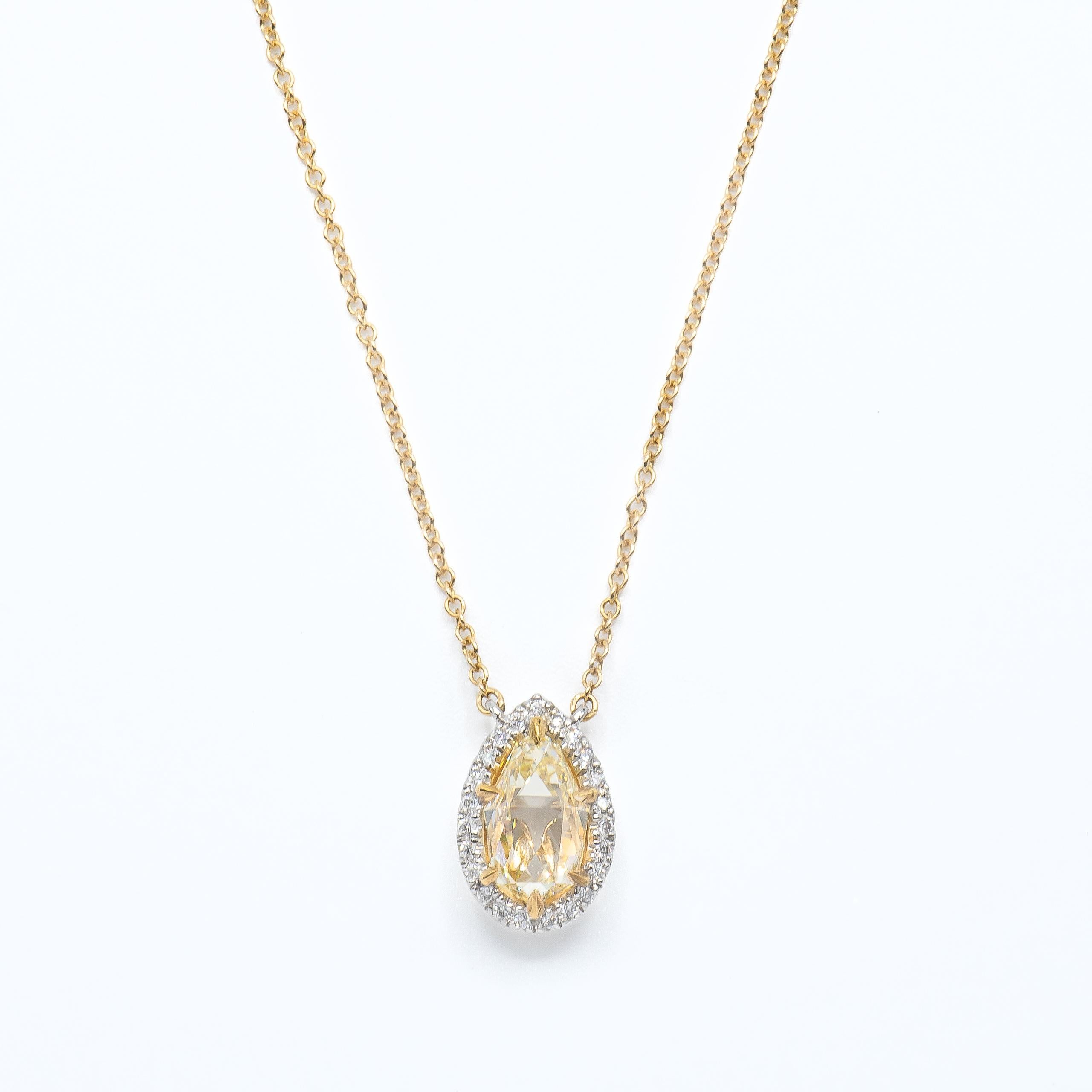 This beautiful pendant features a unique Briolette Cut Diamond weighing 1.87 Carats, certified by GIA as Fancy Light Yellow in color and SI1 in clarity. GIA grades its Polish and Symmetry as Excellent and containing No Fluorescence. 
Surrounded by