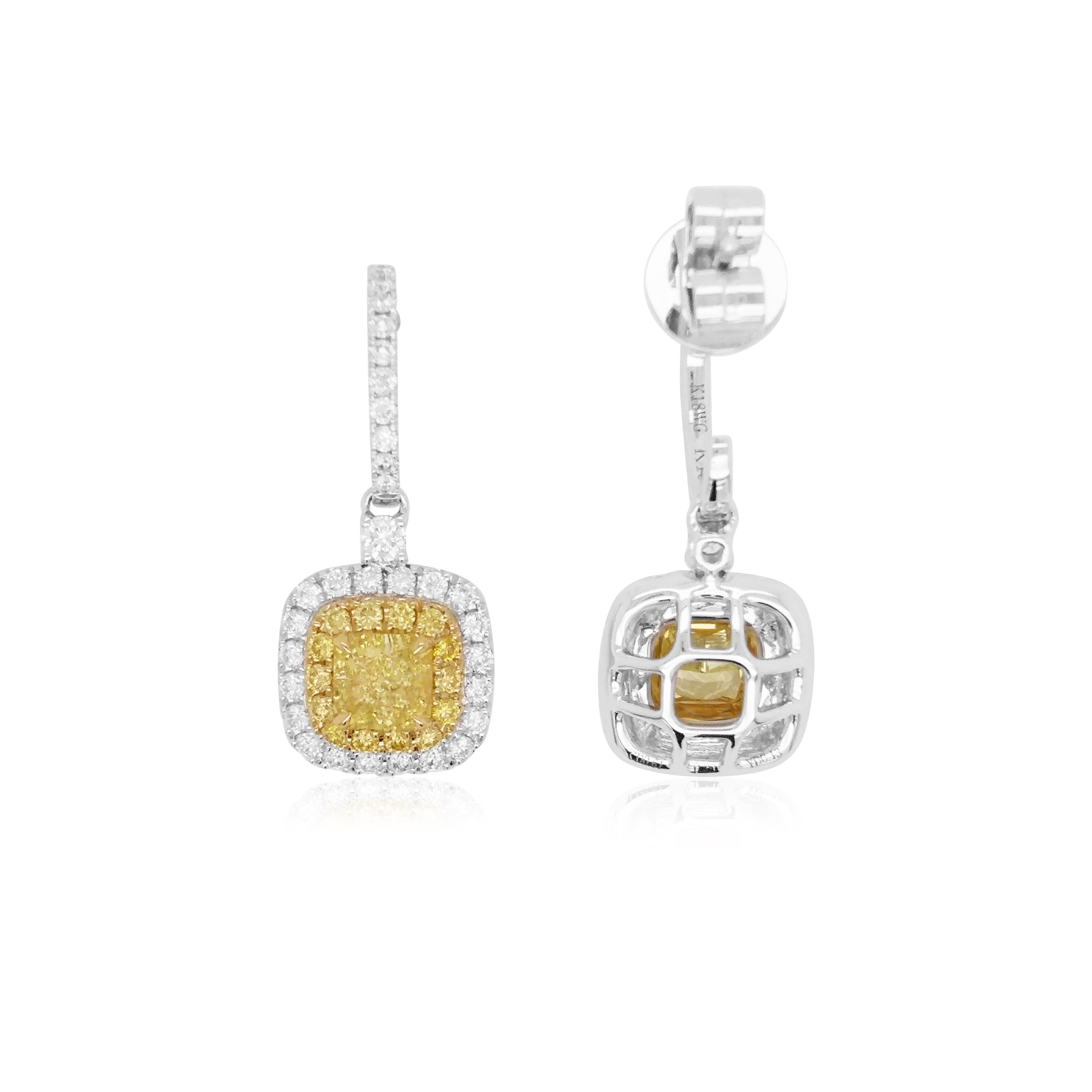 These timeless earrings feature lustrous GIA certified Yellow diamonds, surrounded by a delicate Yellow and White diamond halos, beneath a line of fluid diamonds. Set in 18K white and yellow gold, these earrings are a contemporary classic and will