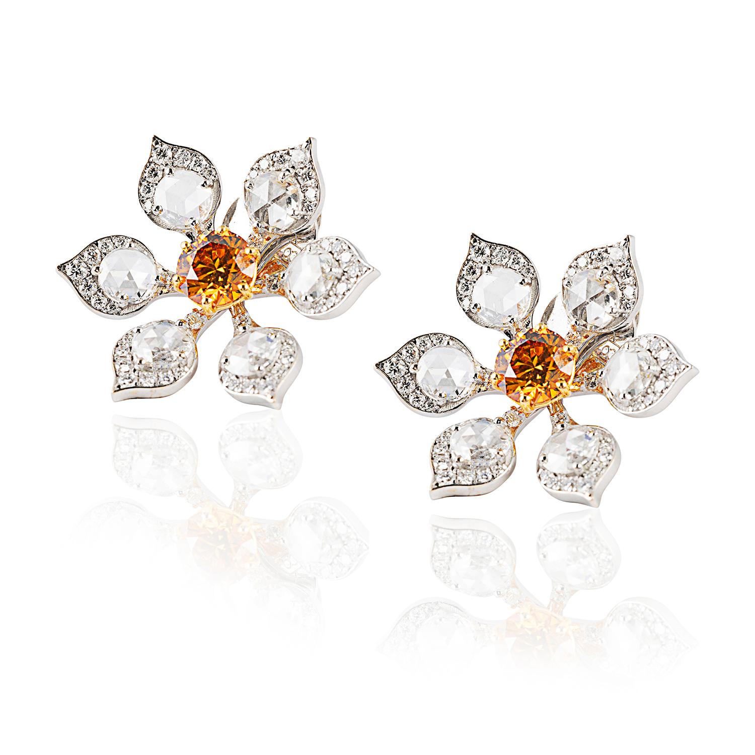 A spectacular pair of GIA certified earrings featuring:
1.25 carats of fancy deep yellowish orange diamonds; 2.17 carat of round brilliant & rose cut diamonds.
6.81 carat of 18kt gold.

Inspired by the gentle beauty & spiritual significance of sun