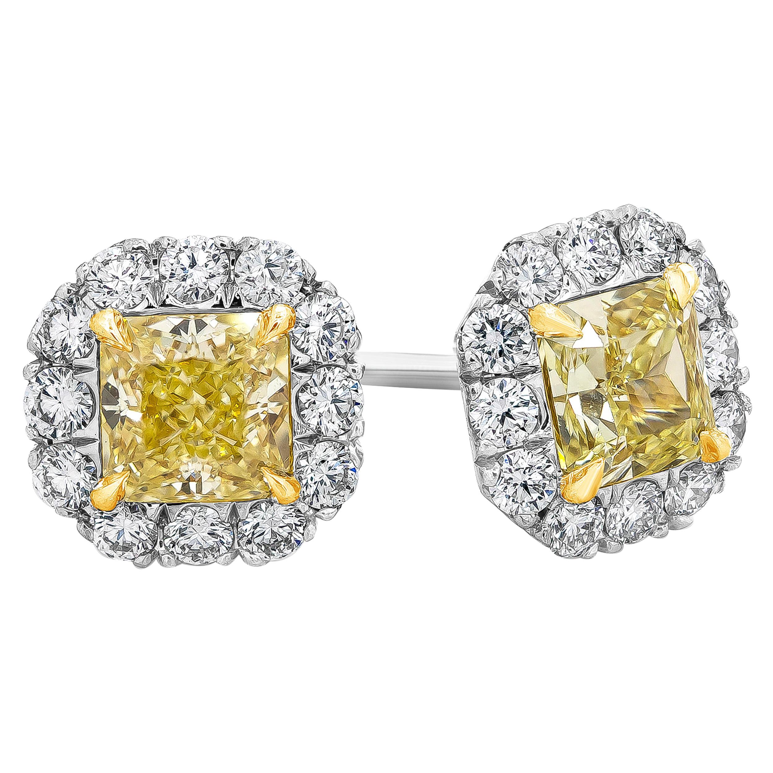 Features two brilliant radiant cut diamonds weighing 1.45 carats total certified by GIA as fancy yellow diamonds and VS1-VS2 in clarity. Surrounded by a single row of round brilliant diamond weighing 0.53 carats total, F color and VS in clarity.