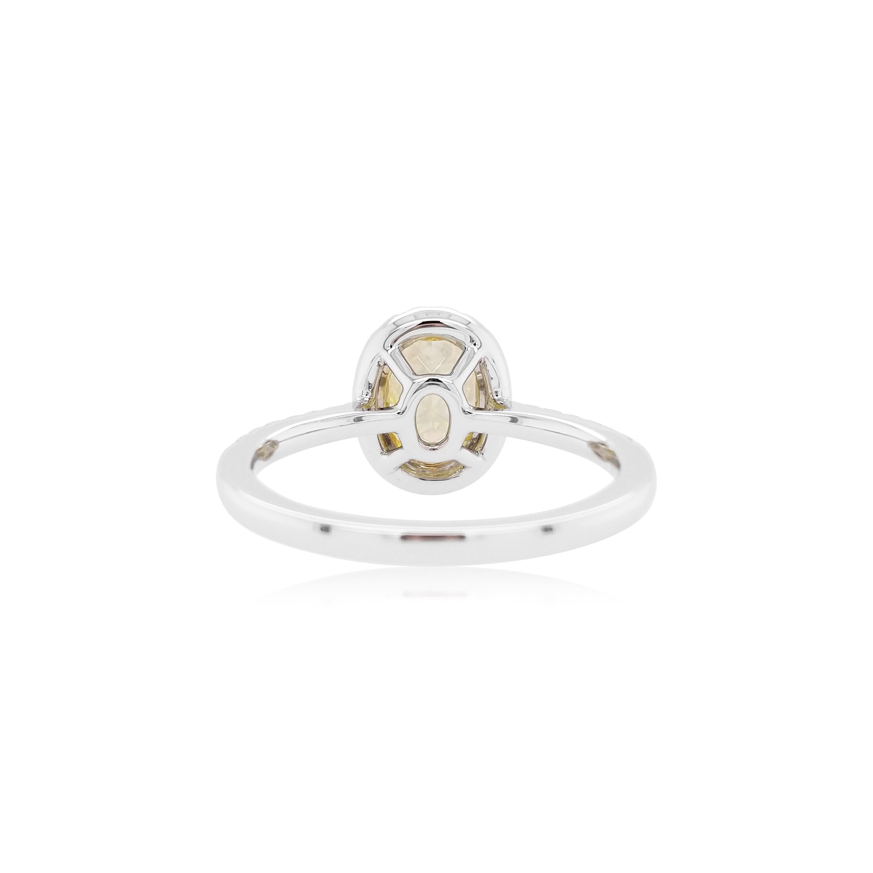 This exclusive bridal ring features a luscious Yellow diamond at the heart of the design, by framing a delicate halo of glittering white diamonds. Set in 18K gold, bold and striking, this unique ring is the perfect statement piece. Each diamond is