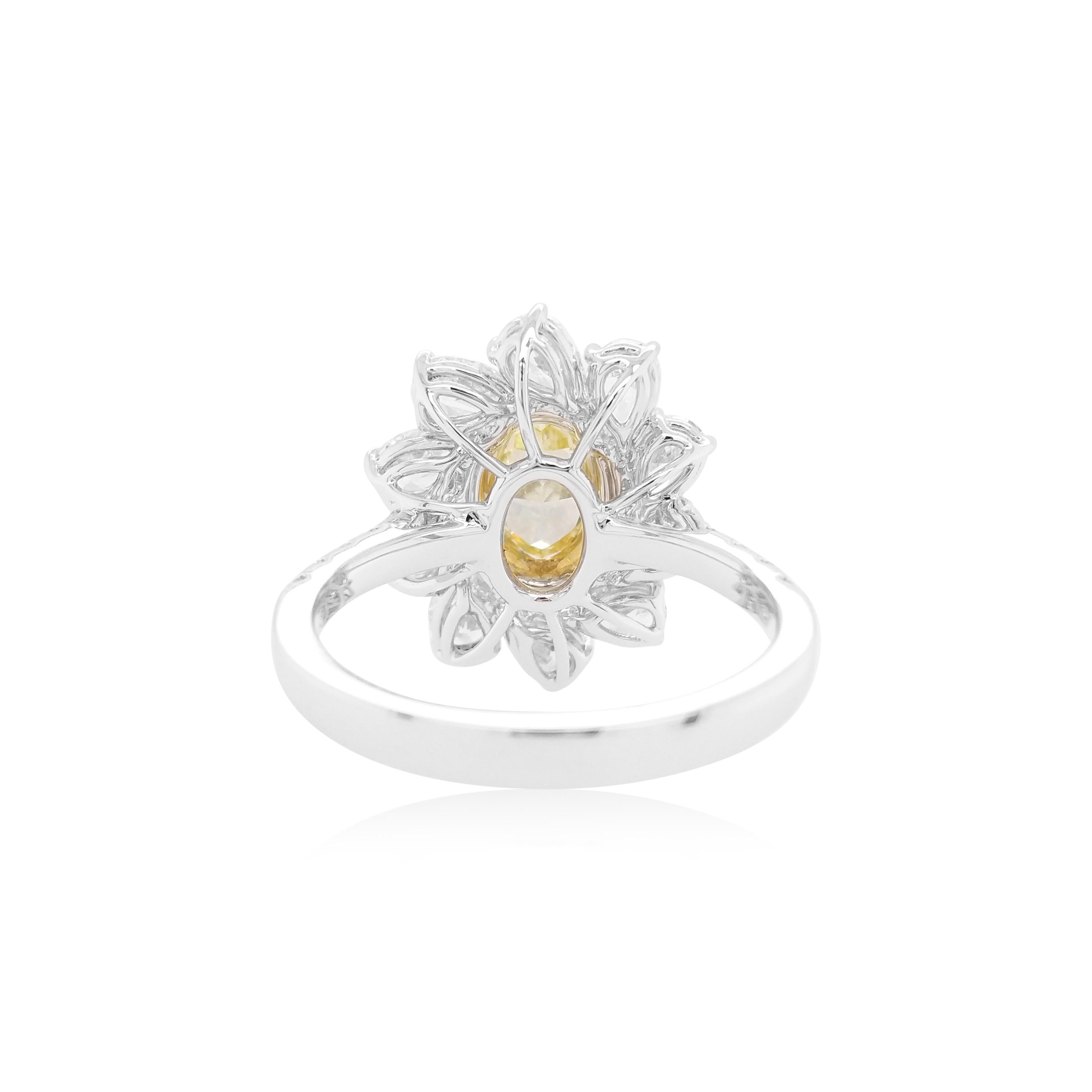 This exclusive Engagement ring features a luscious Yellow diamond at the heart of the design, by framing an ornate arrangement of delicate pear-shaped white diamonds set in 18K gold. Bold and striking, this unique ring is the perfect statement piece