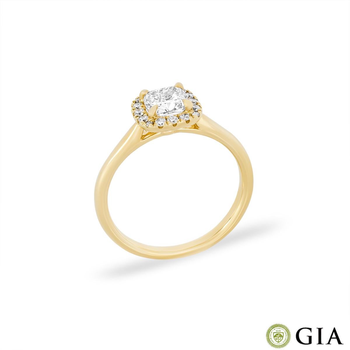 A gorgeous 18k yellow gold diamond halo engagement ring. The ring features a cushion cut diamond set to the centre weighing 0.71ct, I colour and SI1 clarity. The ring is further complemented with a halo made of 16 round brilliant cut diamonds