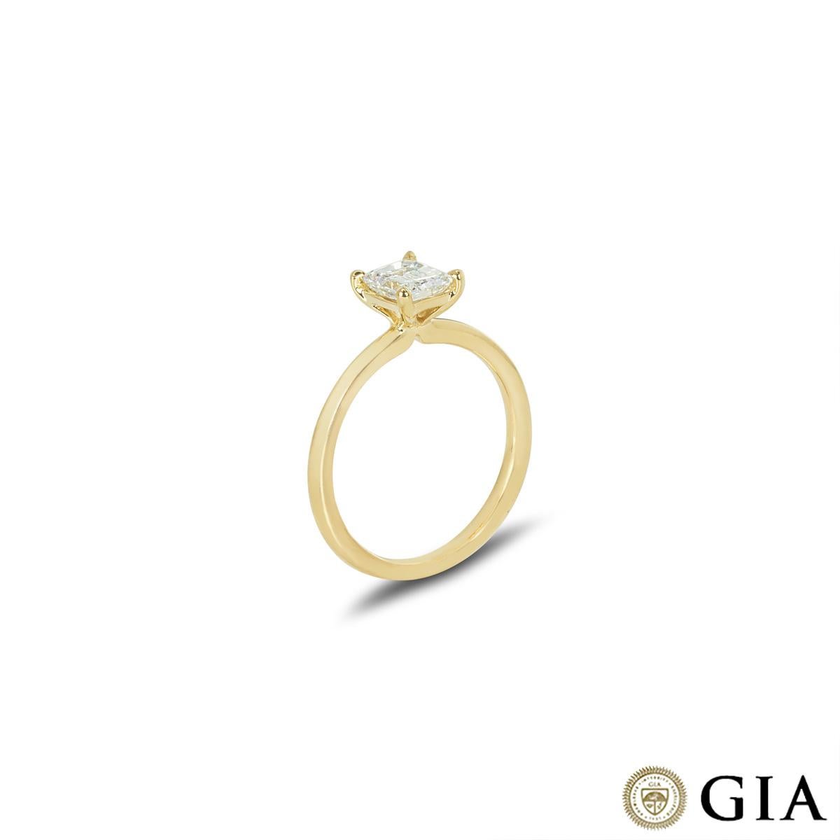 A captivating 18k yellow gold diamond engagement ring. The solitaire features an emerald cut diamond weighing 0.83ct, E colour and VS1 clarity. The diamond is set in a four prong mount on a classic 2mm band, has a gross weight of 3.16 grams and is
