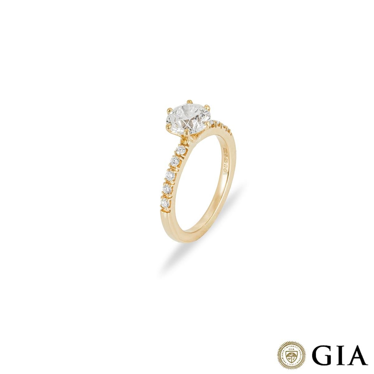 A sparkly 18k yellow gold diamond engagement ring. The ring is set to the centre with a round brilliant cut diamond in a classic 6 claw mount weighing 1.57ct, G colour and VS2 clarity. Further complementing the centre diamond are 5 round brilliant