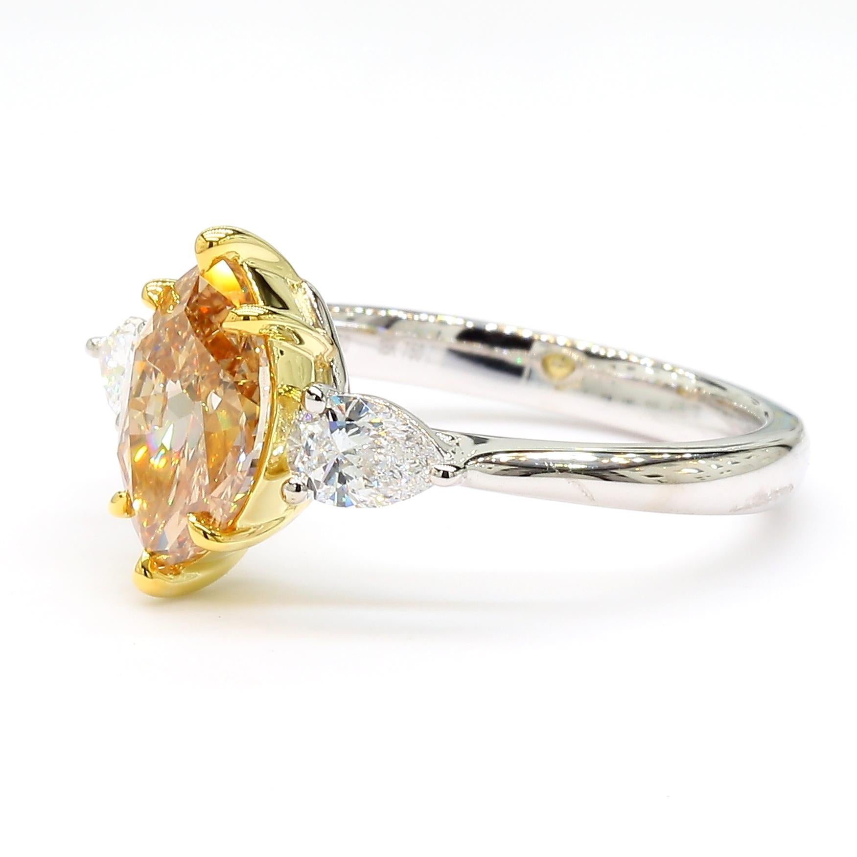 RareGemWorld's beautiful GIA certified diamond ring. Mounted in a beautiful 18K Yellow Gold and Platinum setting with a natural marquise cut yellow diamond surrounded by two natural pear cut white diamonds. This ring is guaranteed to impress and