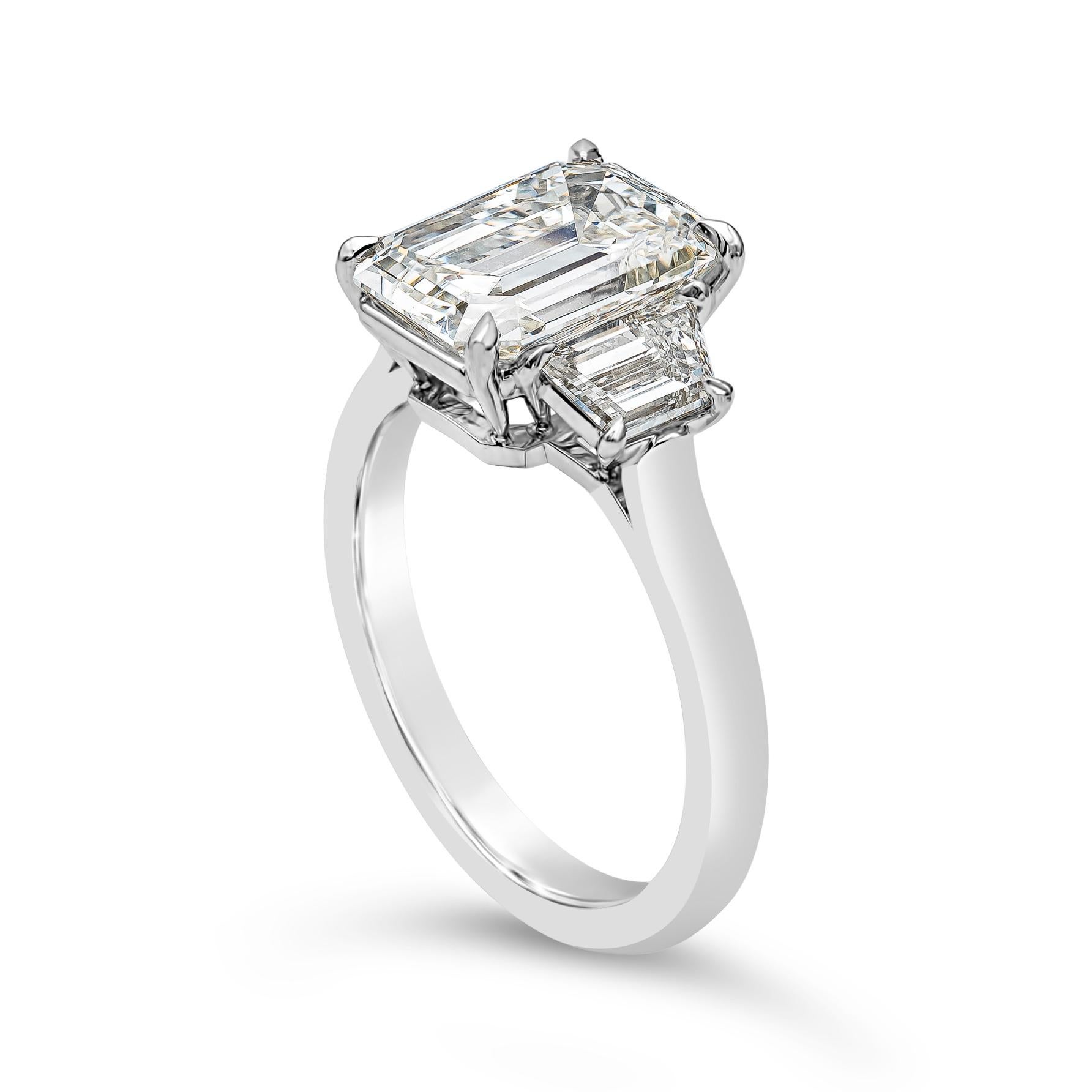 Features a 3.21 carat emerald cut diamond certified by GIA as K color, SI2 clarity, flanked by step-cut trapezoid diamonds on either side. Set in a platinum mounting. Size 6 US (sizable upon request).

Style available in different price ranges.