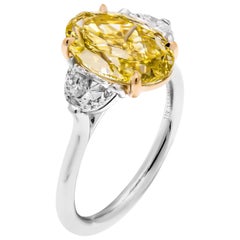 GIA Certifies 3-Stone Ring with 3.27 Carat Fancy Intense Yellow Oval Diamond