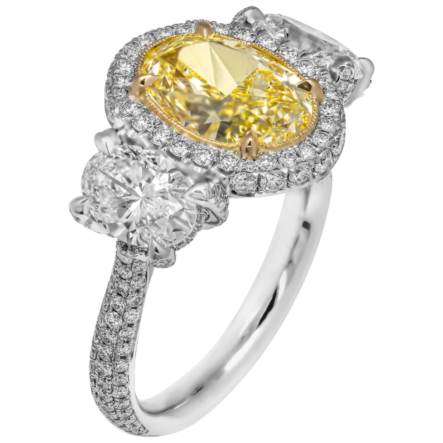 GIA Certifies 3-Stone Ring with 3.52 Carat Fancy Light Yellow Oval Diamond For Sale