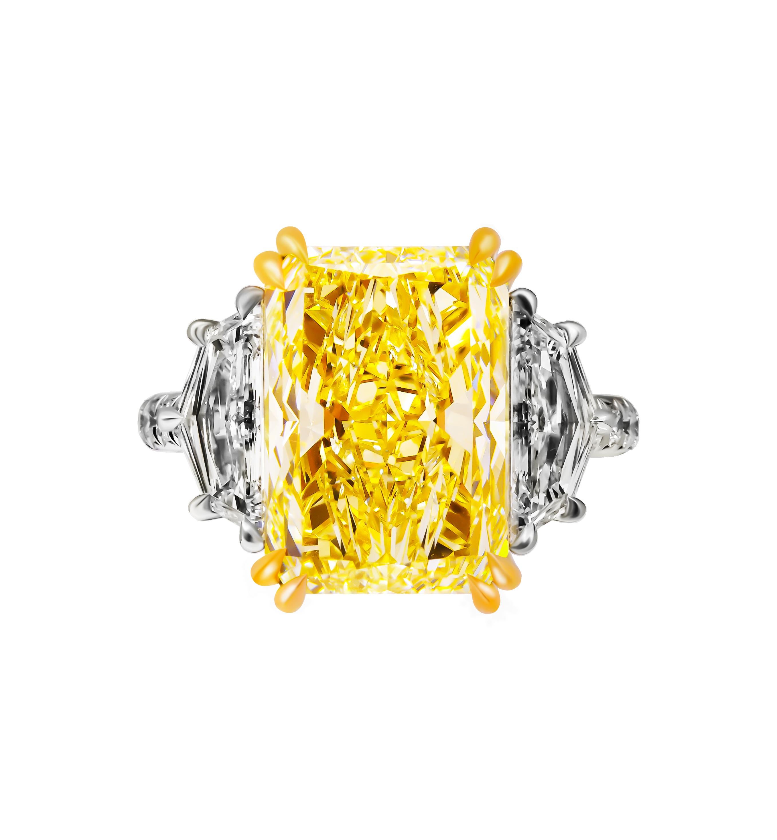 Step into the world of exquisite elegance with this stunning three-stone ring, masterfully crafted in a sophisticated blend of 950 platinum and 18K yellow gold. At the heart of this magnificent piece is a 6.57-carat natural fancy light yellow