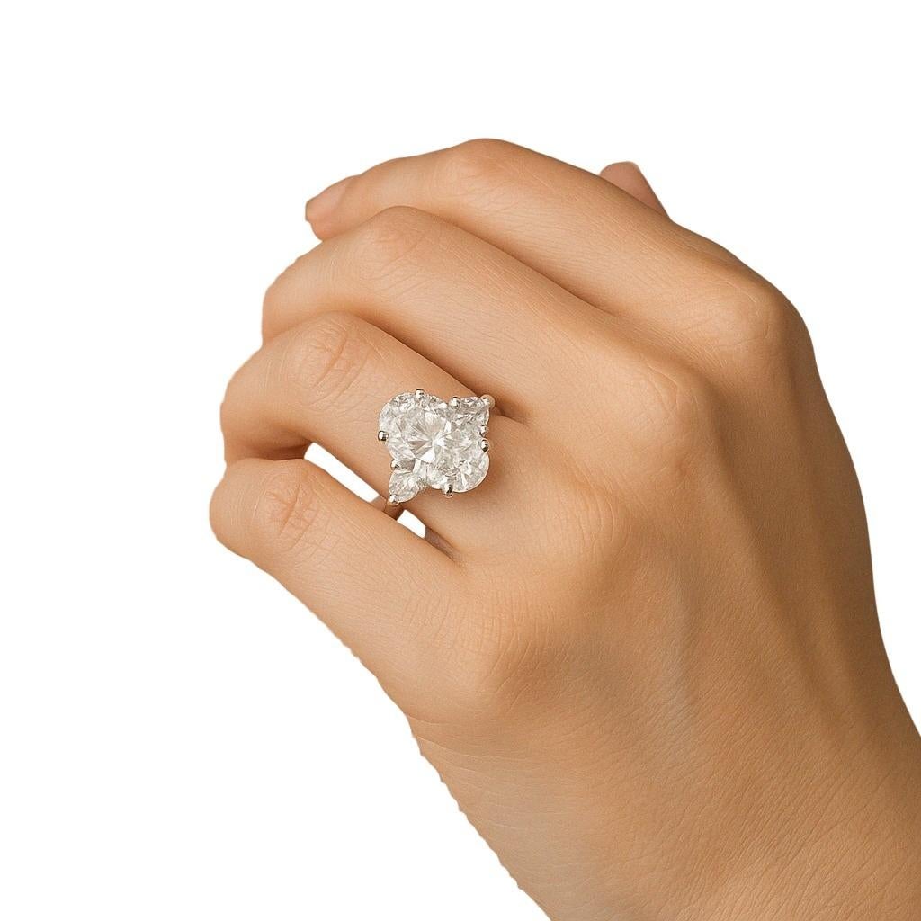 This striking engagement ring showcases a GIA certified 5.00 carat oval cut diamond set in platinum. 

The centerpiece reveals a warm K color that brings a soft and romantic glow. Its clarity is graded VS1, offering exceptional purity with only