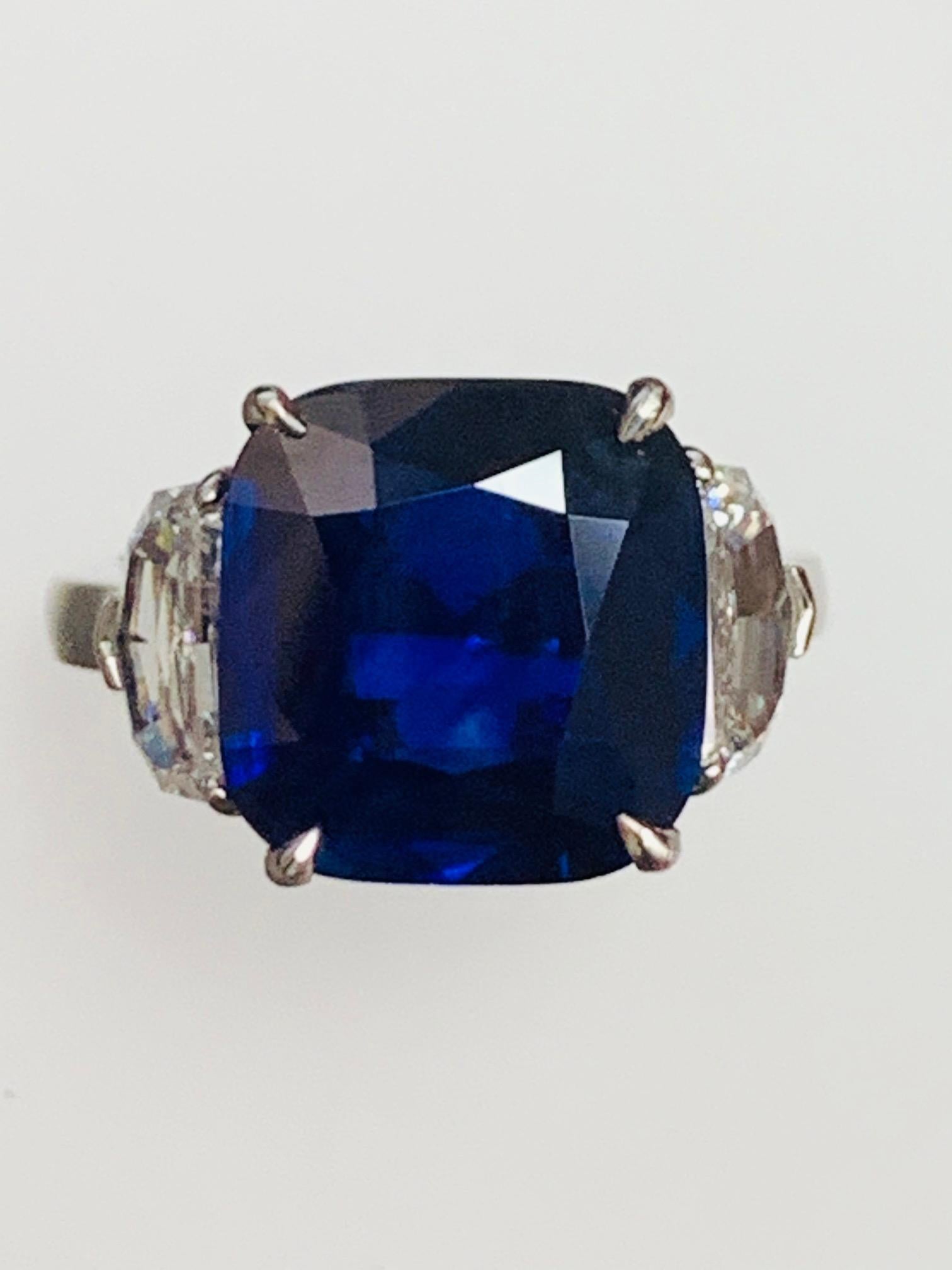 7.38 ct Natural No heat cushion blue sapphire, Madagascar origin , set in classic three stone ring along with 1.40 carat half moon diamonds .