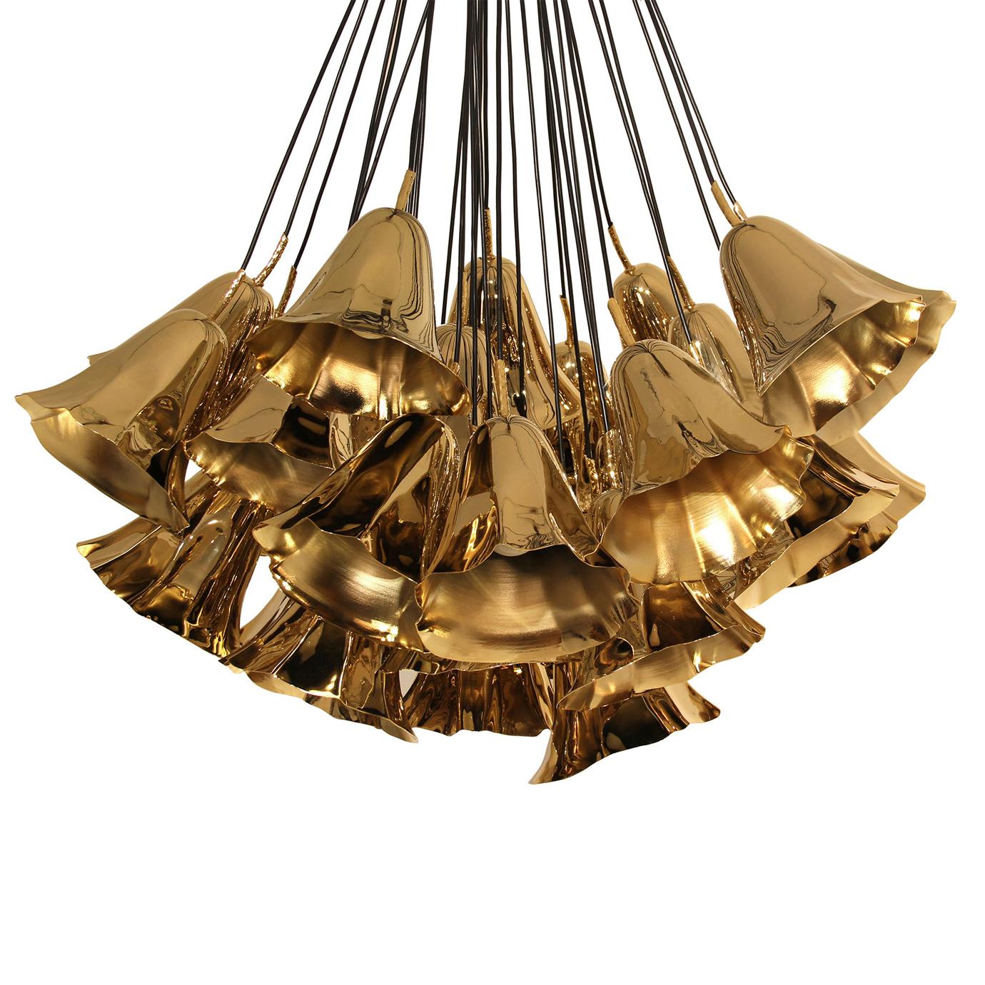 Imagine a bouquet of gentle lily blossoms gracing your ceiling, eternalized in gleaming metallic. The Gia chandelier consists of a hand sculpted metal calla lilies freely suspended from a group of strings.