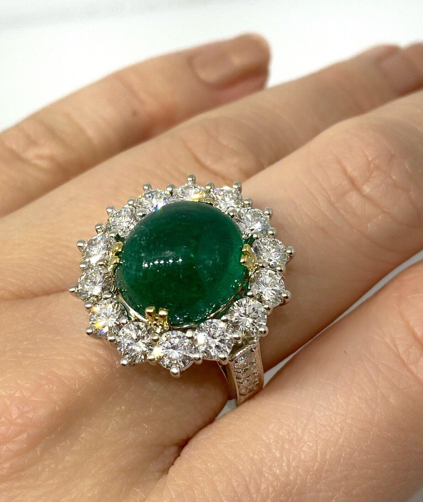 GIA Certified Colombian Emerald Cabochon & Diamond Ring in 18K White Gold

Colombian Emerald and Diamond Ring features a large Oval Emerald Cabochon surrounded by 14 Round Brilliant Diamonds set in 18k White Gold.

The emerald originates from