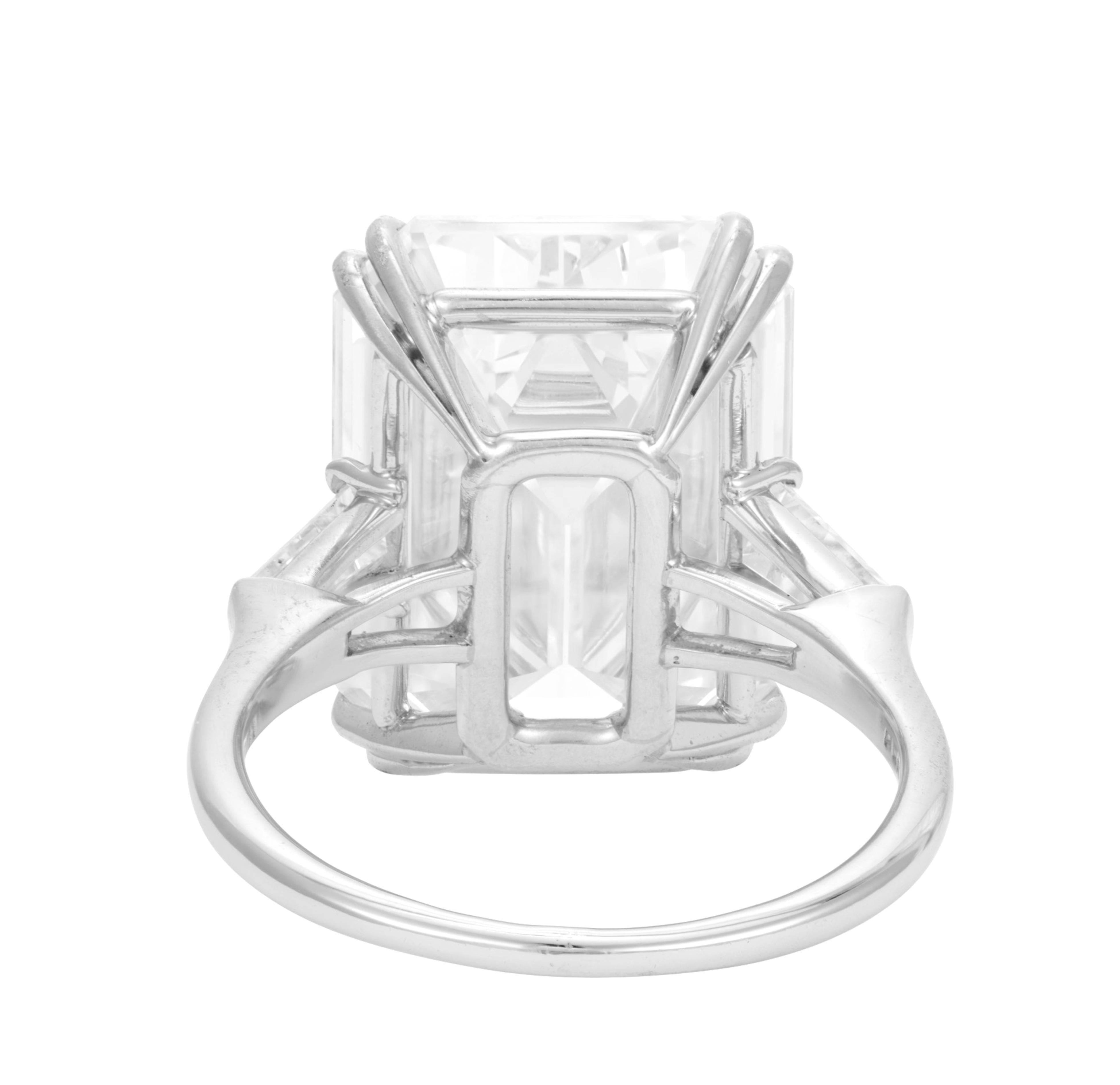 10.11ct Total Weight Emerald Cut Diamond three-stone engagement ring is an exquisite piece crafted in platinum. The centerpiece is a stunning 10.11 ct natural emerald cut diamond that boasts an G color grade and Vs2 clarity, indicating exceptional
