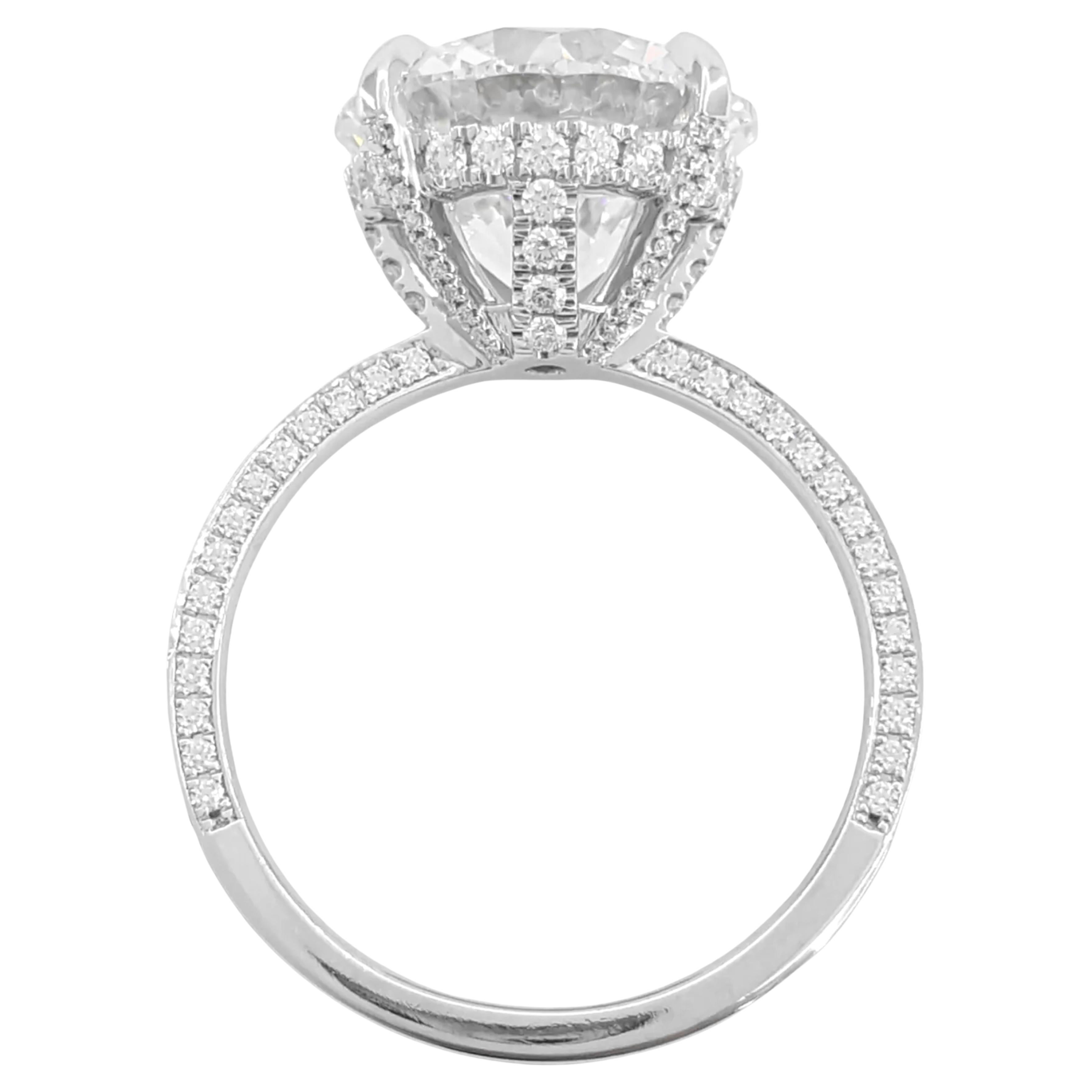 An  Engagement Ring featuring a 5.12 ct total weight with a round brilliant cut diamond set in a platinum halo.

The ring is size 7.5, highlighted by a natural round brilliant cut diamond in the center, weighing 5.12 ct, with an F color grade and I