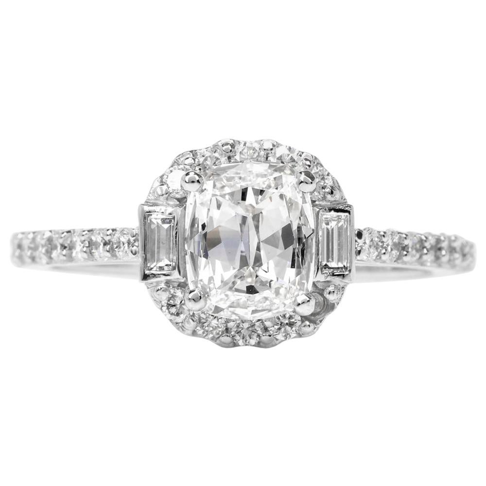 This enchanting diamond engagement ring is crafted in solid platinum. Prong-set with a centered GIA lab reported cushion-brilliant-cut diamond weighing approx. 0.75 carats, graded H color and VS1 clarity. In between two smaller baguette-cut