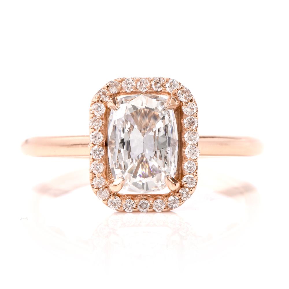 This stunning diamond engagement ring is crafted in 18K rose gold. Displaying a prominent four prong set cushion cut GIA certified diamond approx. 0.93 CT, D color, VS2 clarity. Surrounded by a halo of 25 pave set round-cut diamonds, further