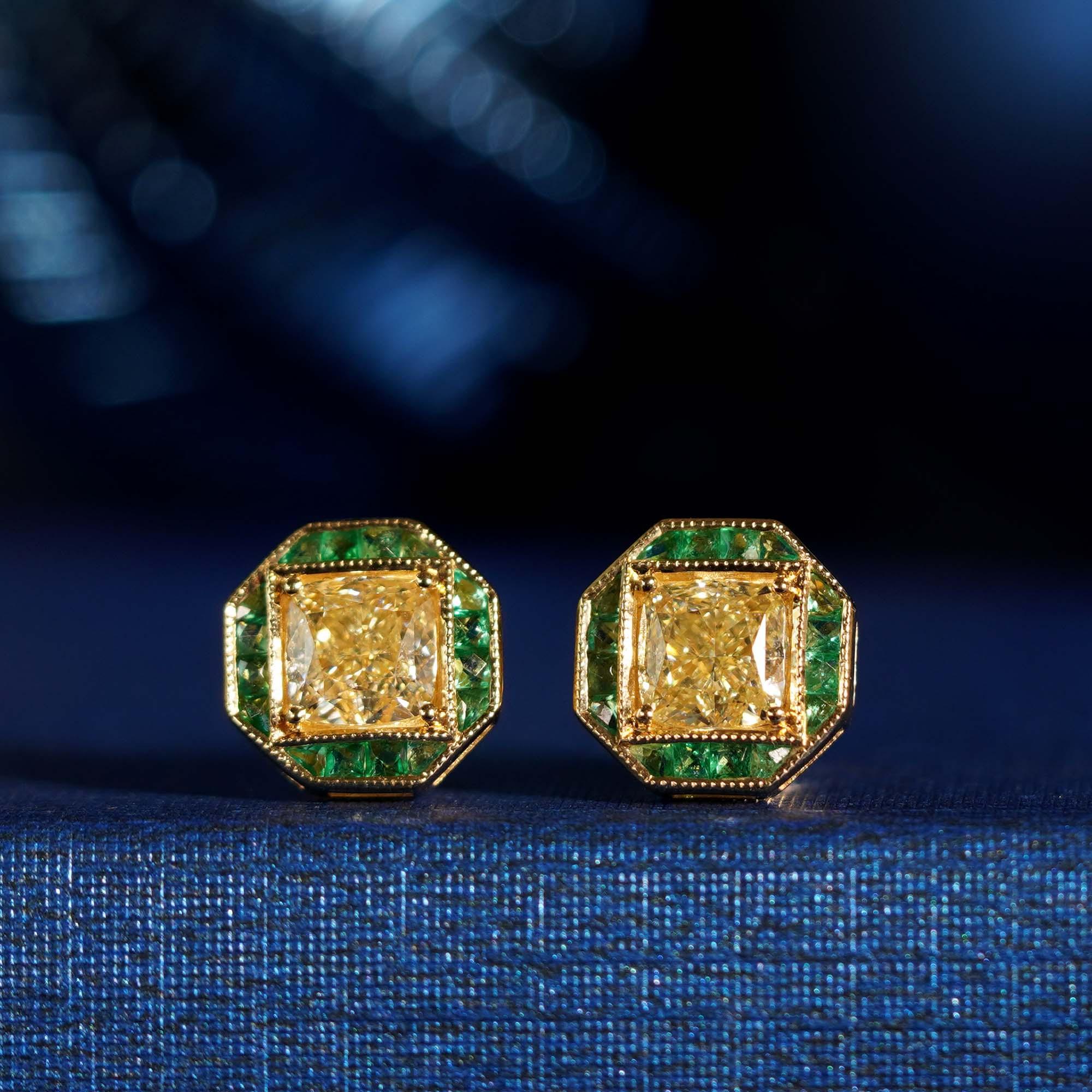 A spectacular pair of diamond and emerald stud earrings featuring total of 1.42 carat GIA certified diamonds and French cut emeralds secured in a statement bezel setting.

Earrings Information
Metal: 18K Yellow Gold
Width: 9 mm.
Length: 9