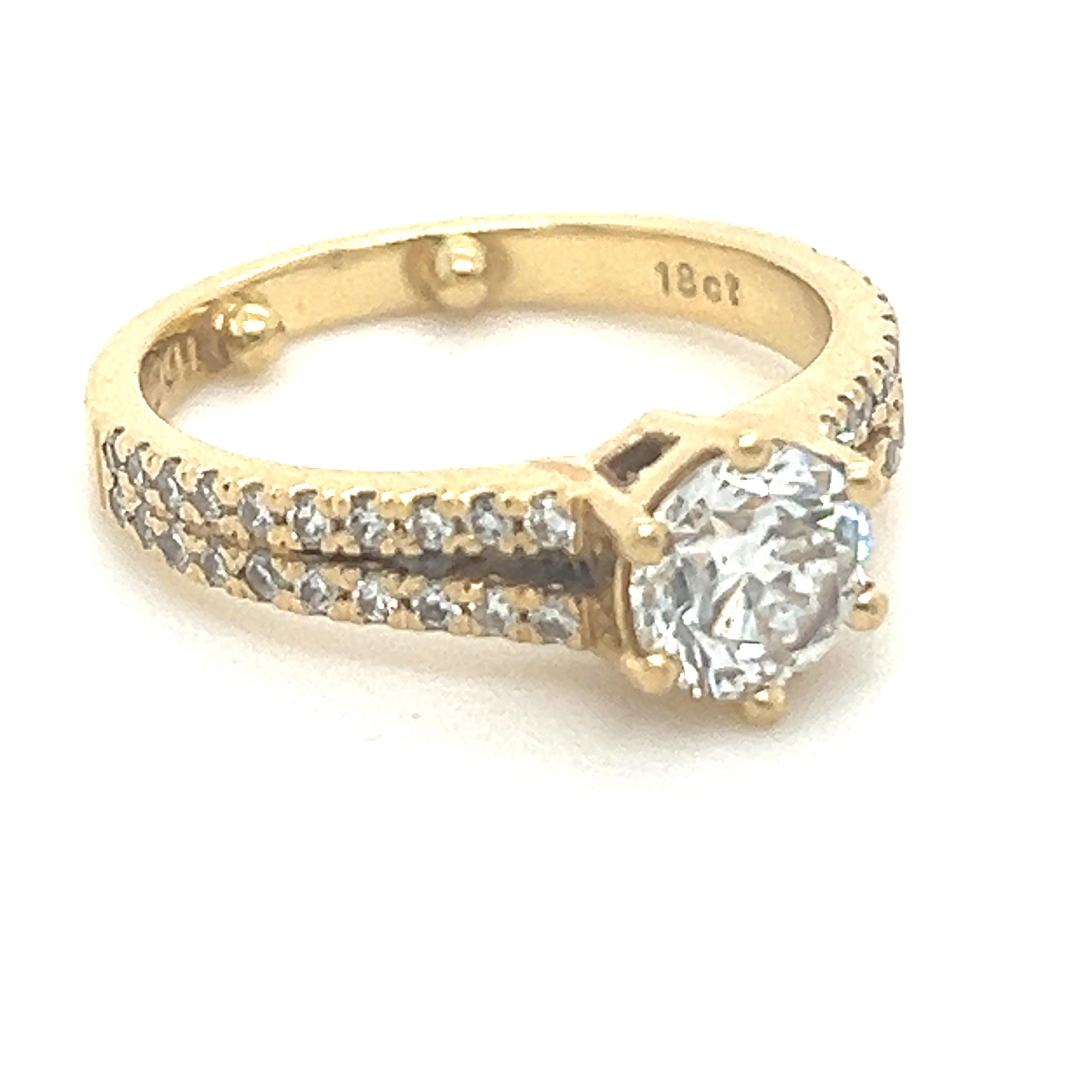 A GIA 18ct Yellow Gold Engagement Ring as sample set with:

Centre Diamond = 1.00ct. Colour: H, Clarity: SI1. Round Brilliant cut diamond

GIA Report 6305141266 and 40 x +/-0.40ct (total weight)

Colour: G/H Clarity: VS/SI. Round Brilliant cut