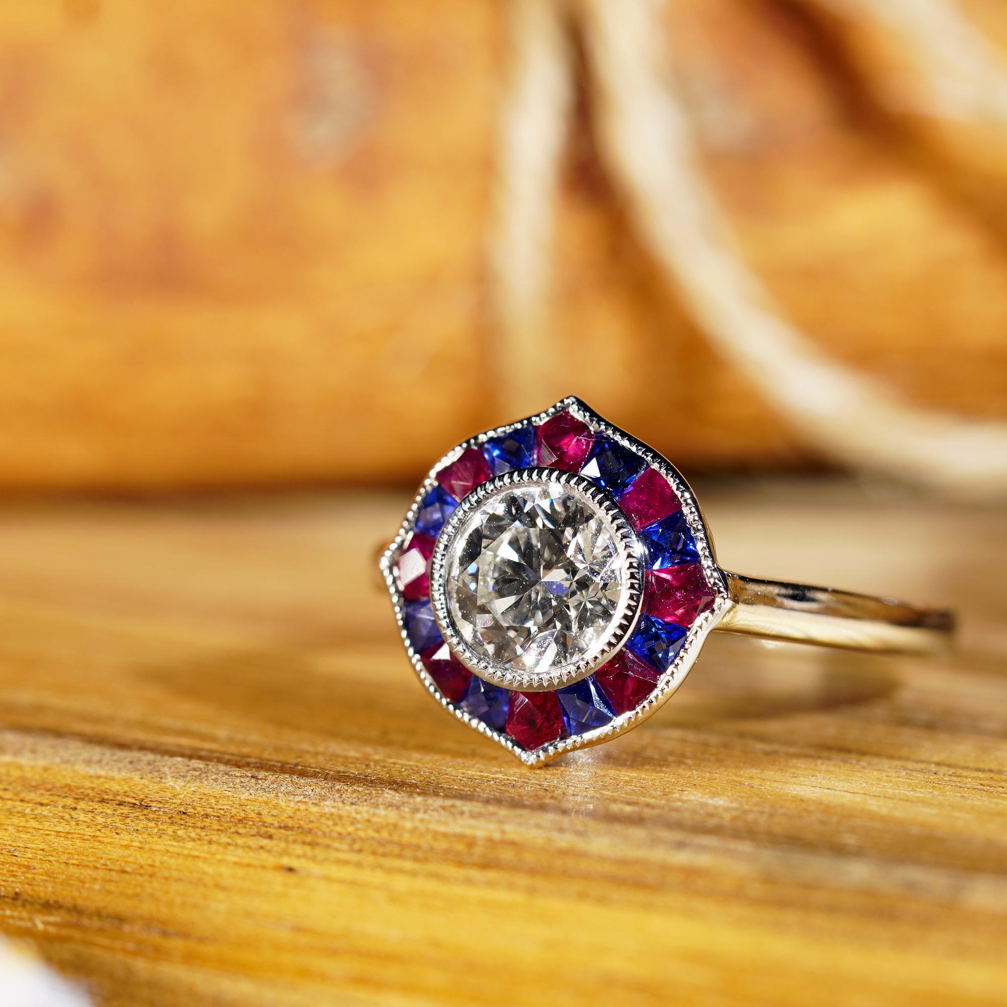 This stunning halo ring sparkles in lustrous platinum 950 and features a 1 carat round diamond at the center with French cut ruby and sapphire in beautiful halo designs. Adorn yourself with an Art Deco inspired jewelry in every occasion in your