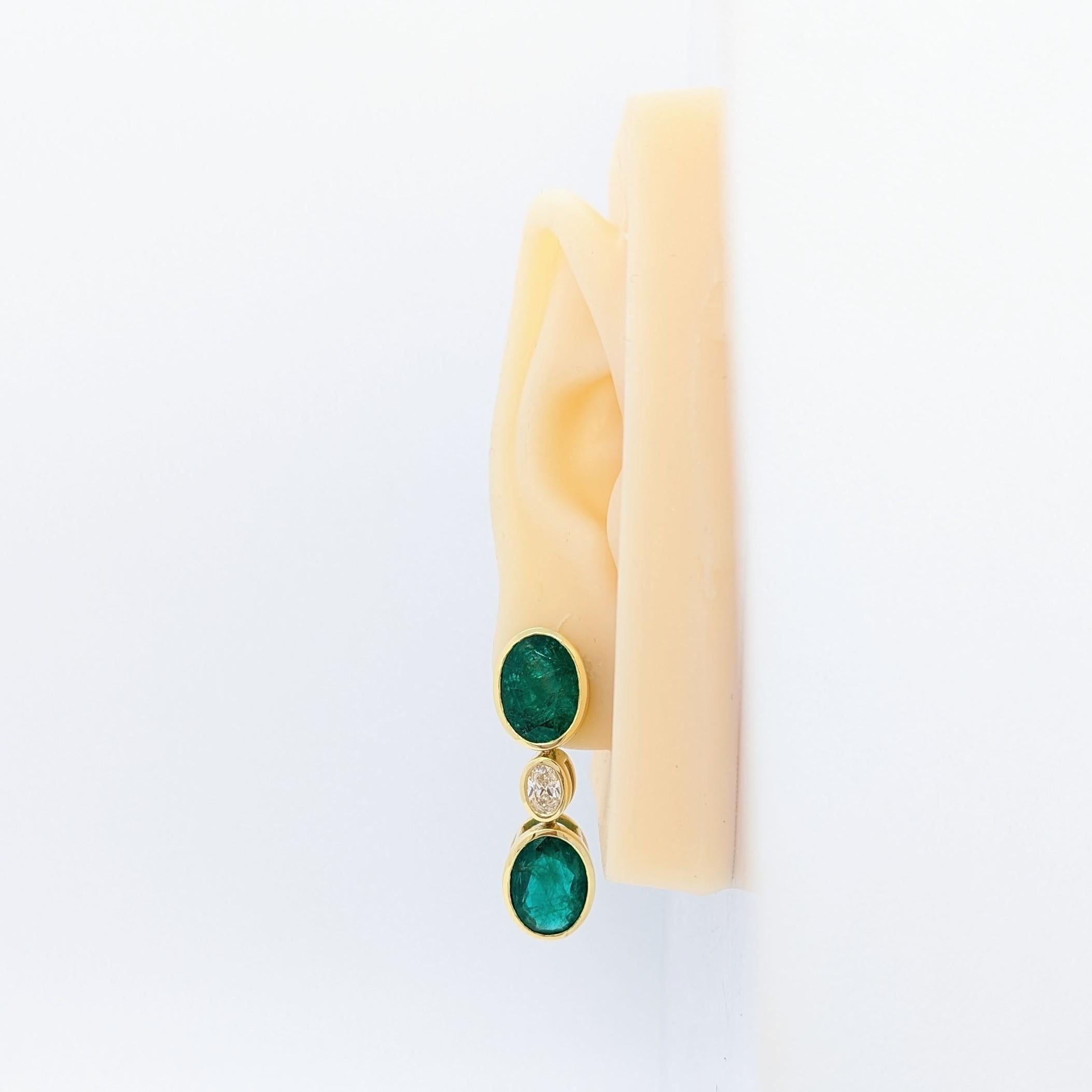 Gorgeous 20.92 ct. emerald ovals with 1.00 ct. H - I white diamond ovals.  Handmade in 18k yellow gold.  Push back setting.
