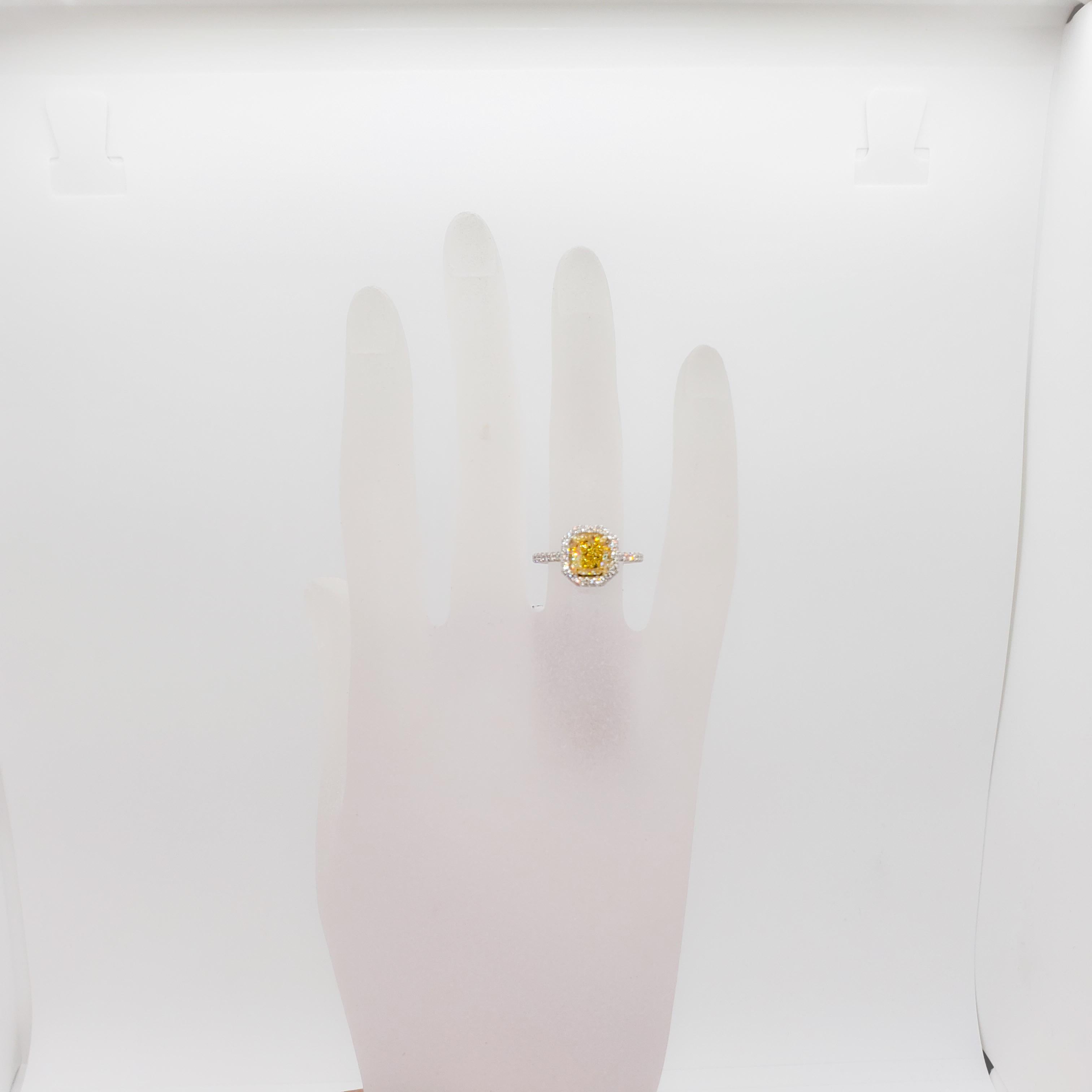 Stunning bright yellow fancy intense radiant diamond weighing 1.61 ct. with 0.35 ct. of good quality white diamond rounds.  Yellow diamond is a VVS2 stone and the perfect sunshine yellow.  Handmade platinum and 18k yellow gold mounting.  Ring size