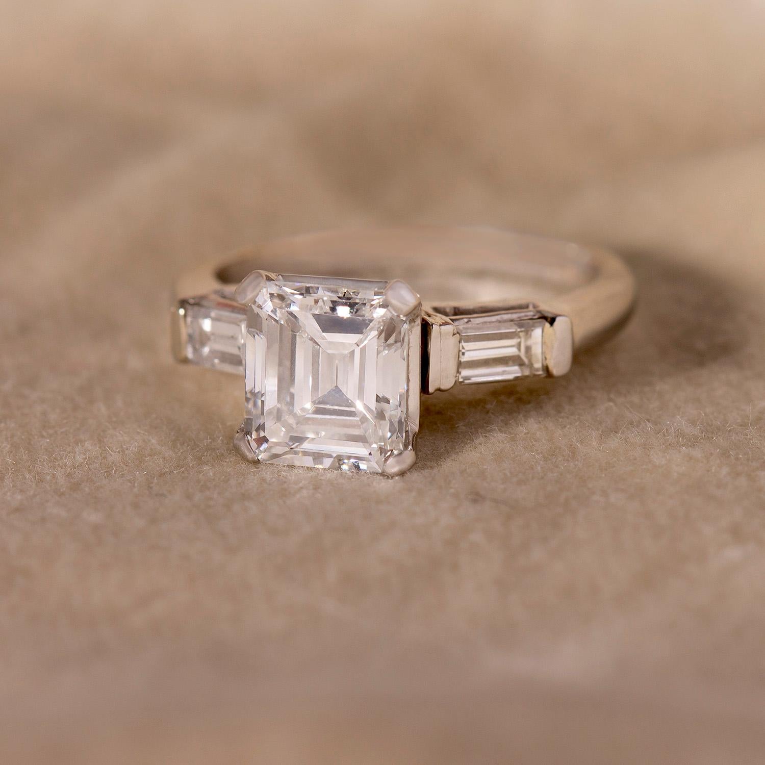 You will get lost in the sharp facets of this sleek mid-century engagement ring. An icy-white emerald-cut center stands bright in the center, flanked by two delicate channel-set baguettes.

Why we love it? This is a classic piece that will never go