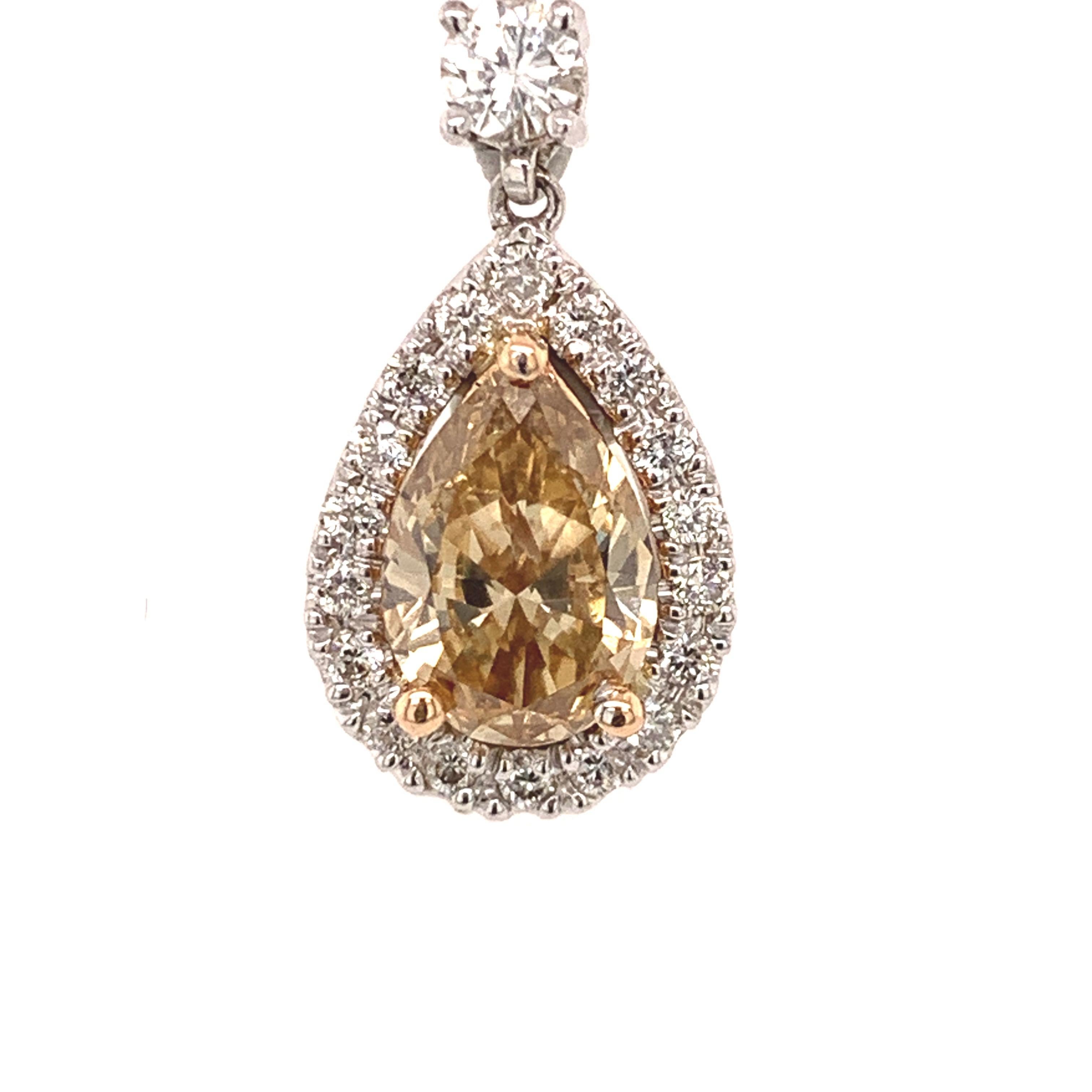 Elegant fancy brown-yellow diamond pendant. High brilliance, pear faceted, GIA certified, 1.11 carats, natural fancy brown-yellow diamond encased in three bead prongs, accented with a round brilliant cut diamond on the bail and framing the pear