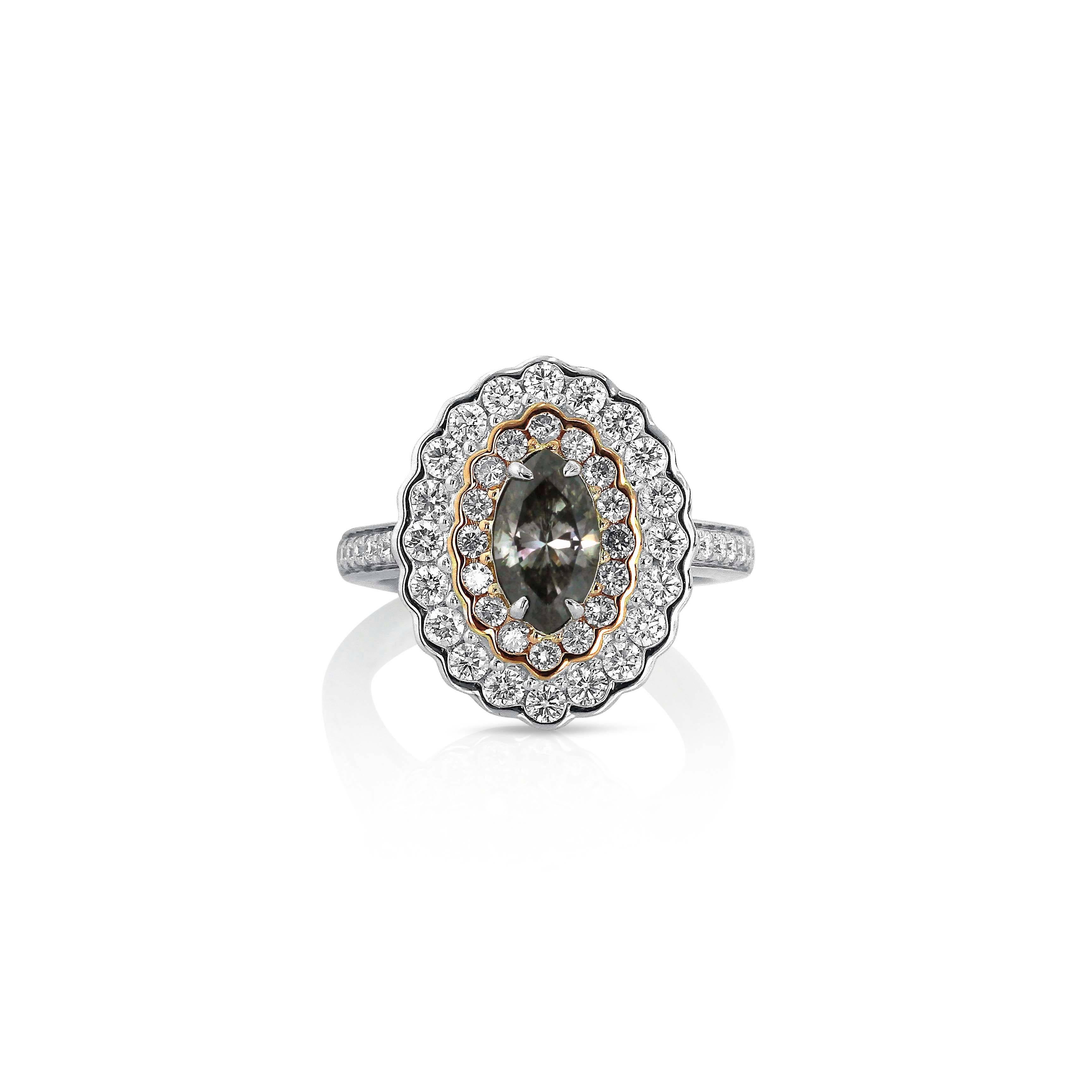 A rare gray diamond is framed by a modified double halo; the innermost halo is composed of pink diamonds and the outer halo is of white diamonds. A scalloped edge accentuates the roundness of the smaller diamonds while emphasising the long curve of