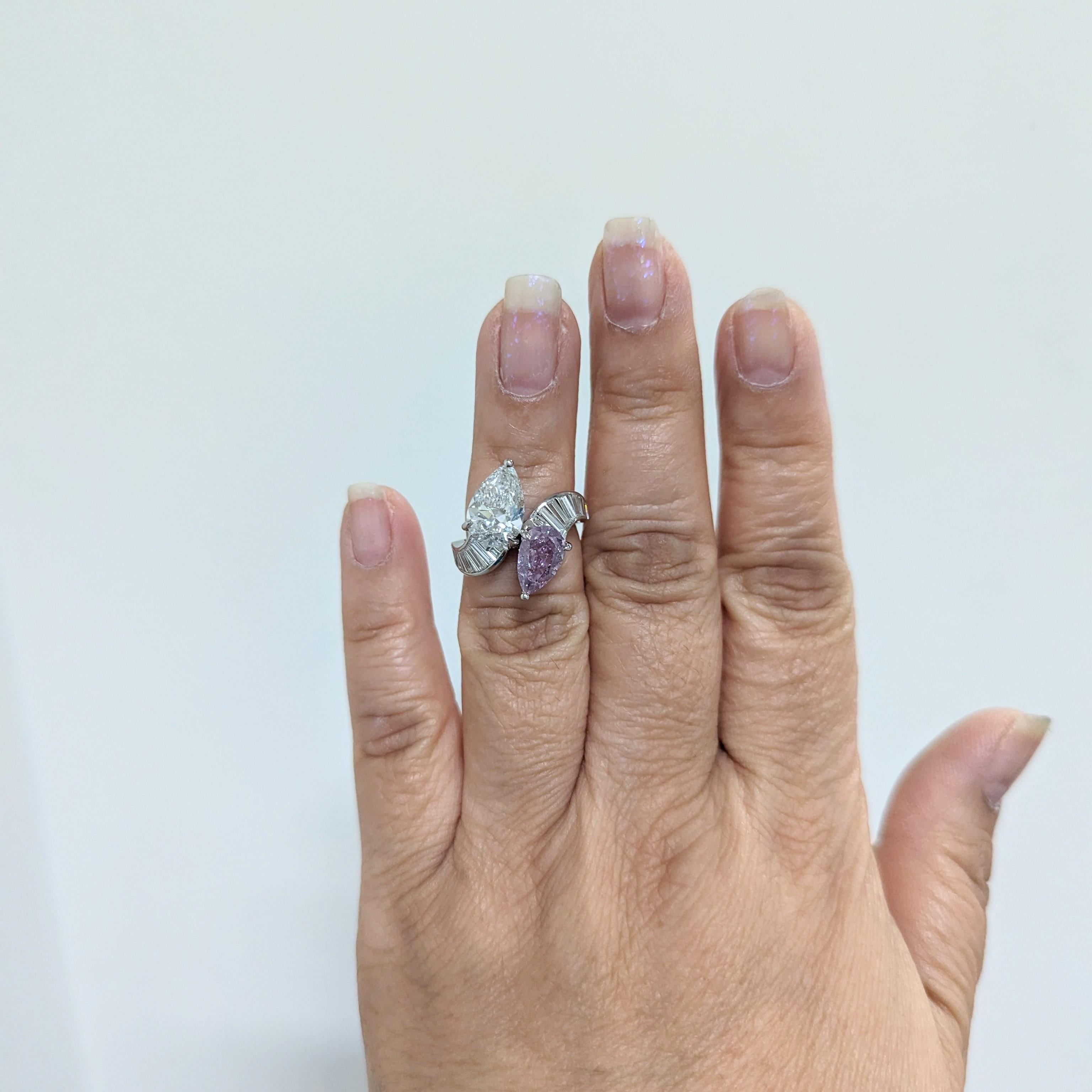 Absolutely stunning 2.01 ct. fancy intense pinkish purple pear shape diamond with a 3.01 ct. F SI2 white pear shape diamond.  This bypass ring is rare and one of a kind.  A sophisticated and elevated addition to any jewelry collection.  Ring size