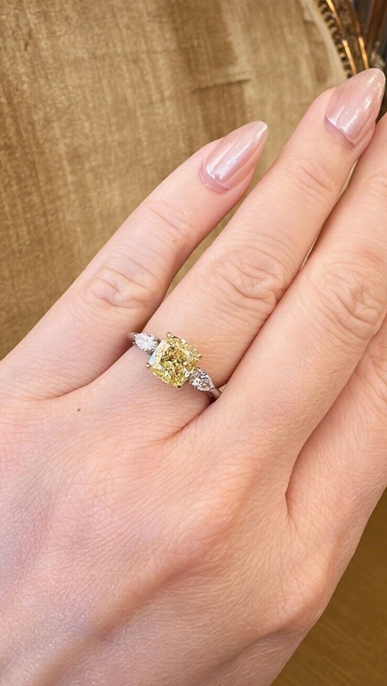 GIA Fancy Intense Yellow Diamond 2.01 carat Three-stone ring in Platinum and 18k In Excellent Condition For Sale In La Jolla, CA