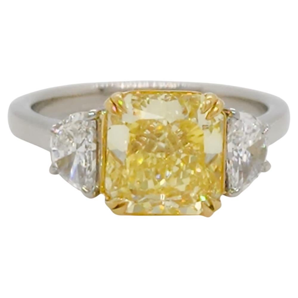 GIA Fancy Intense Yellow Diamond Radiant Three Stone Ring in Platinum and 18k For Sale