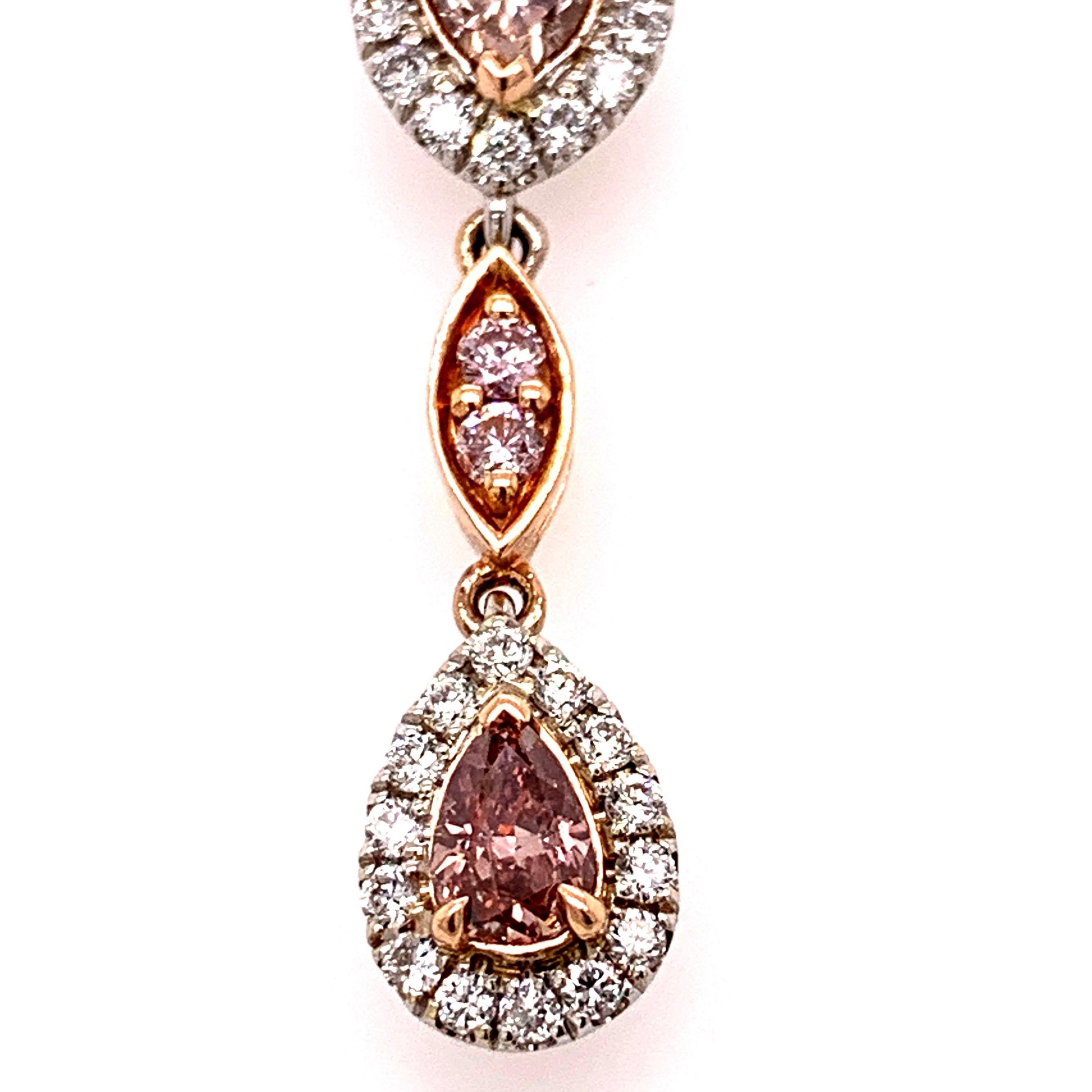 Elegant fancy orangy pink diamond earrings. High lustre, 0.23carat, 0.21 carat, (Gia), pear faceted, two natural fancy deep orangy pink diamond, dangling with two heart faceted fancy pink diamonds, surrounded with round brilliant cut diamonds and