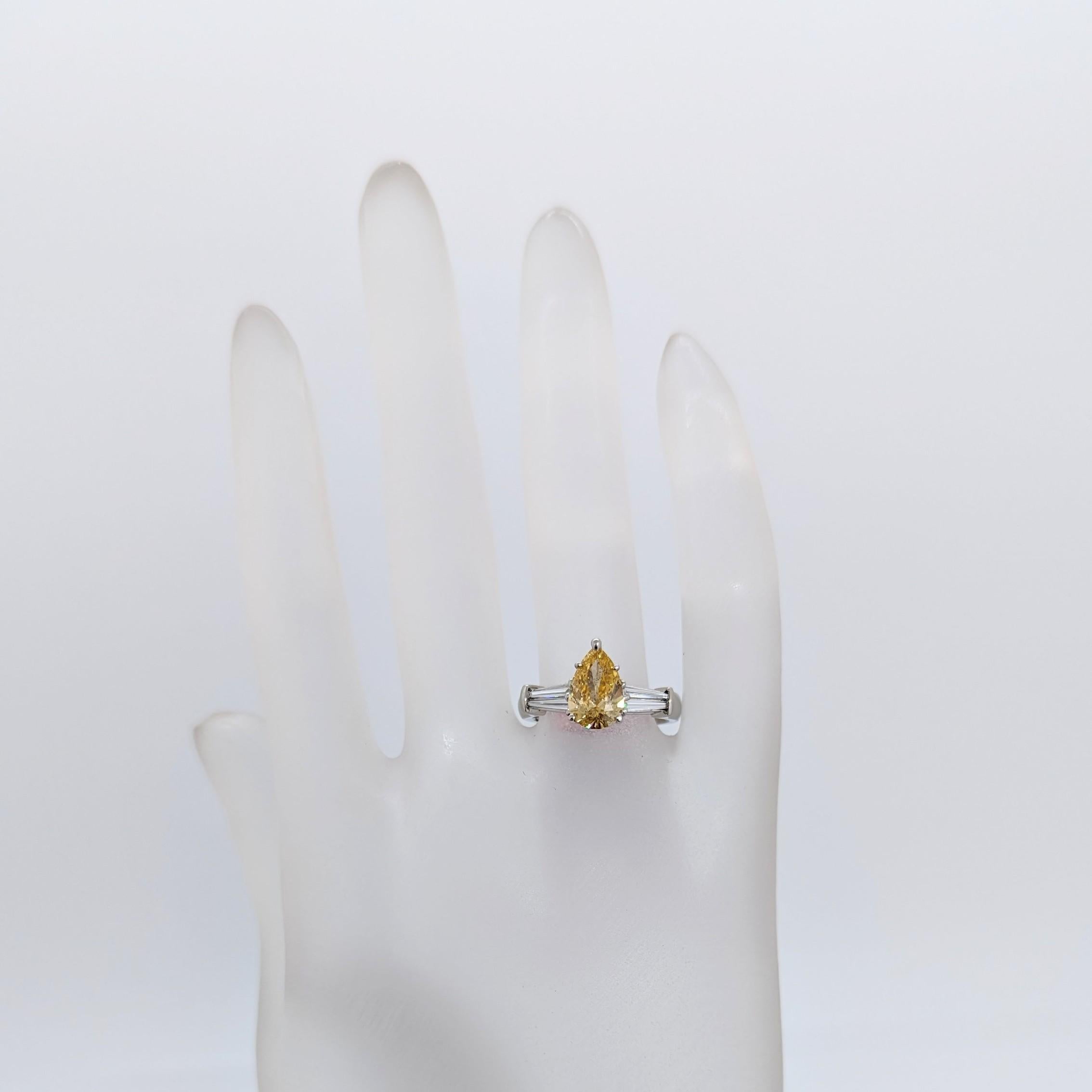 Pear Cut GIA Fancy Orangy Yellow Pear and White Diamond Three Stone Ring in Platinum For Sale