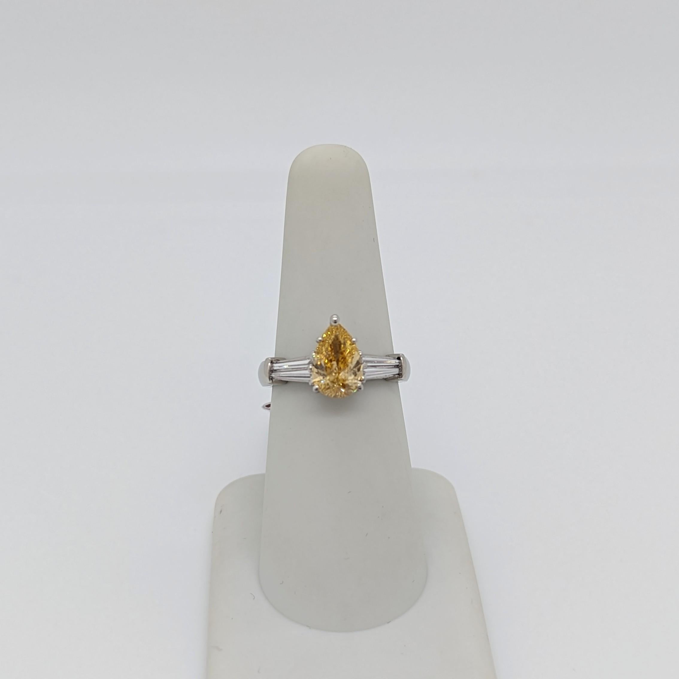 GIA Fancy Orangy Yellow Pear and White Diamond Three Stone Ring in Platinum In New Condition For Sale In Los Angeles, CA