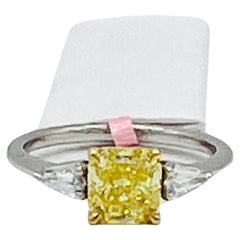 GIA Fancy Vivid Yellow Cushion and White Diamond Three Stone Ring